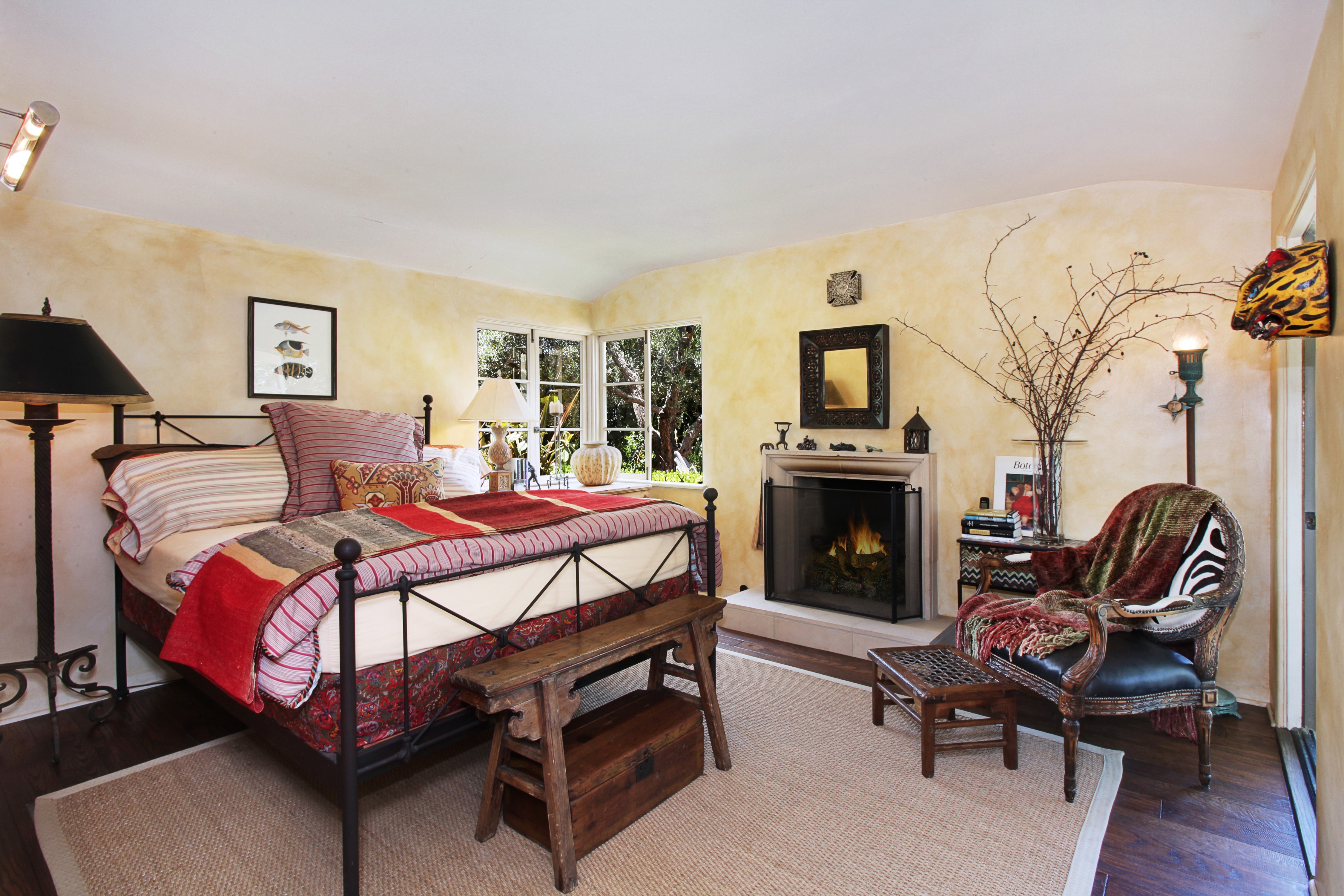 Bedroom with fireplace and armchair HD Wallpaper