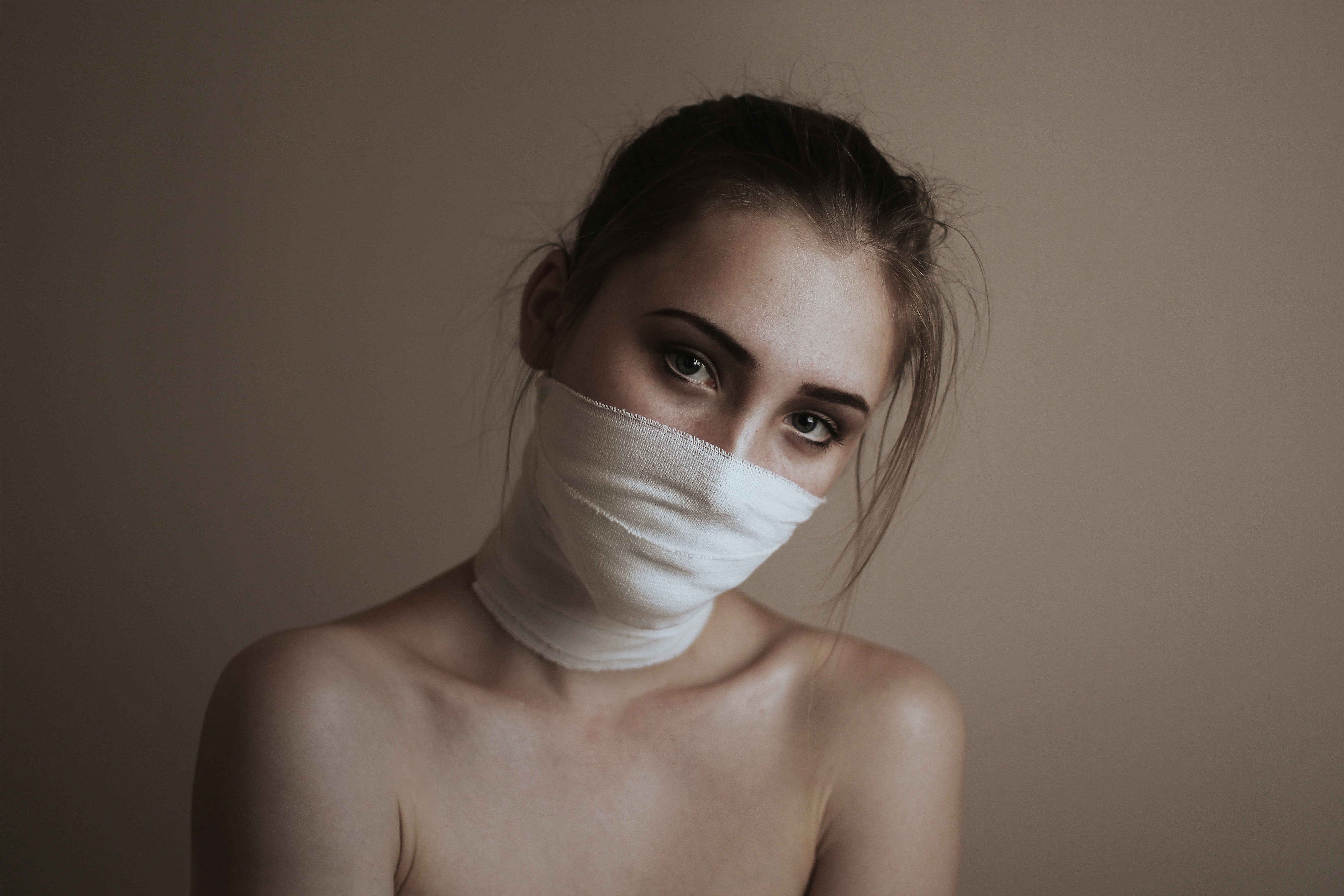 Woman with bandages on face HD Wallpaper