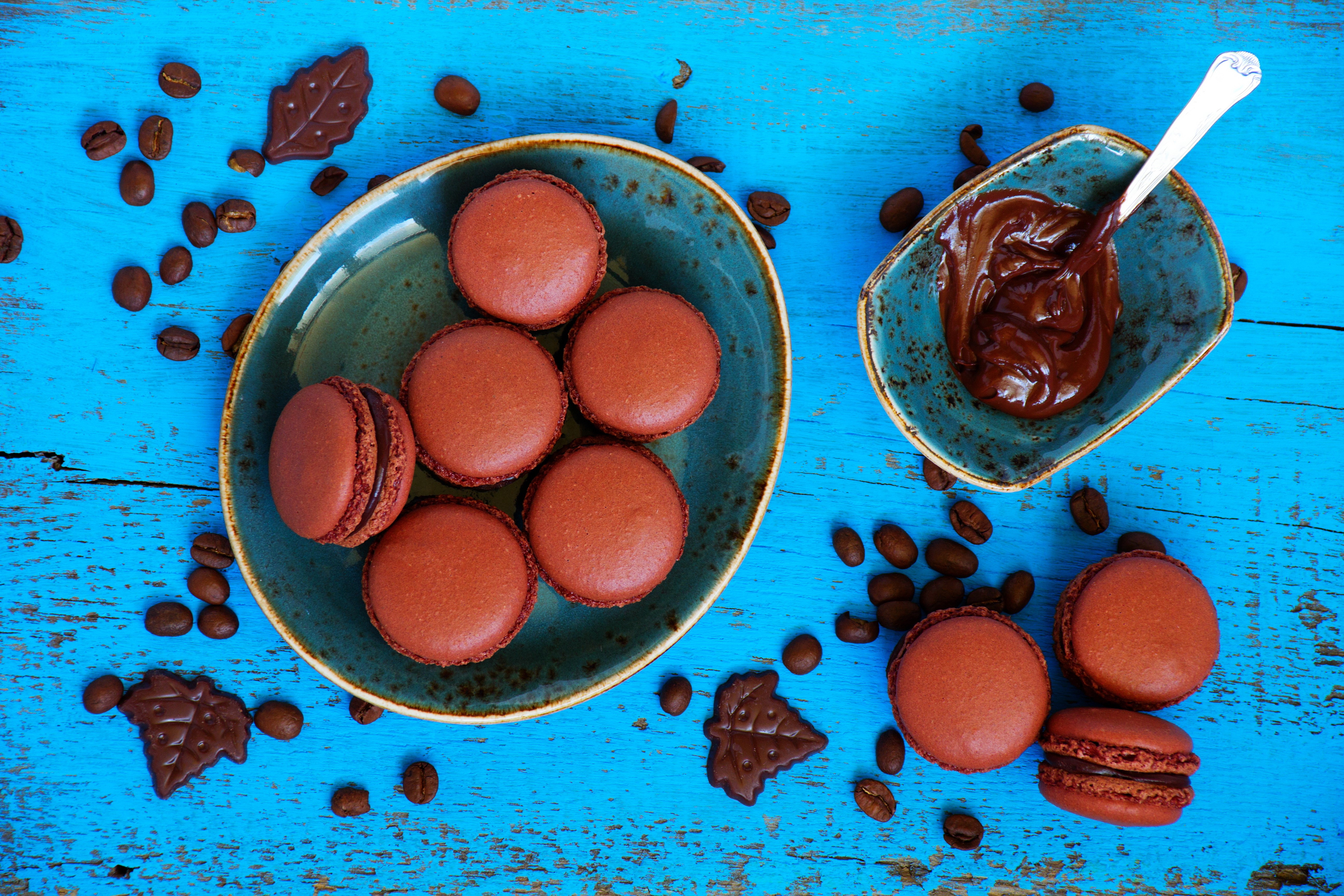 Chocolate Macarons and Coffee Beans on Blue Wood HD Wallpaper