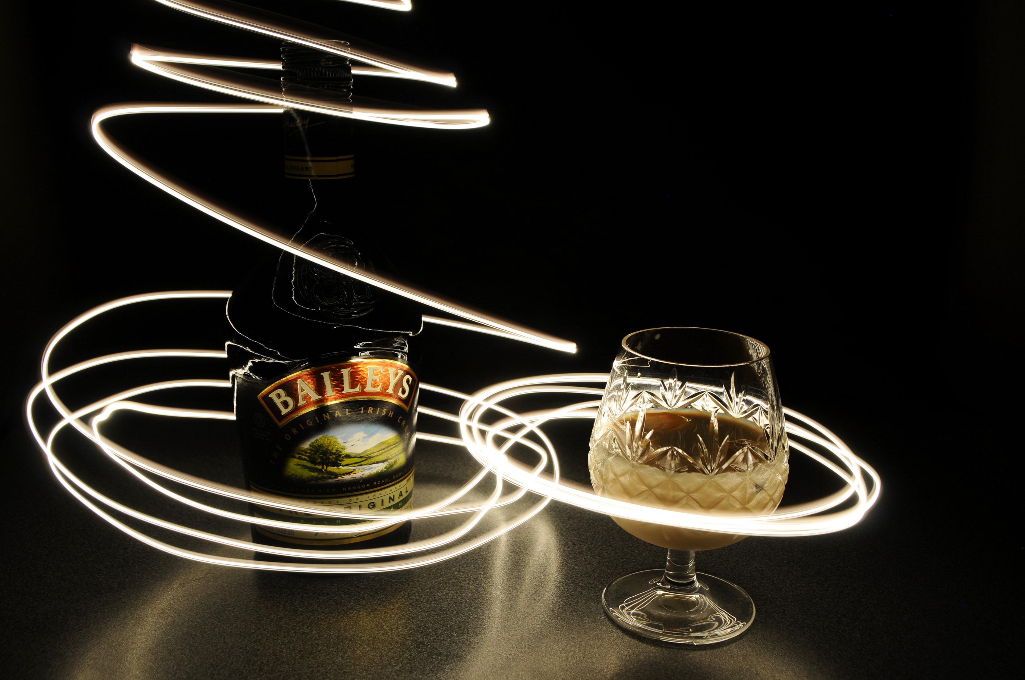Baileys Original Irish Cream bottle and glass with light painting HD Wallpaper
