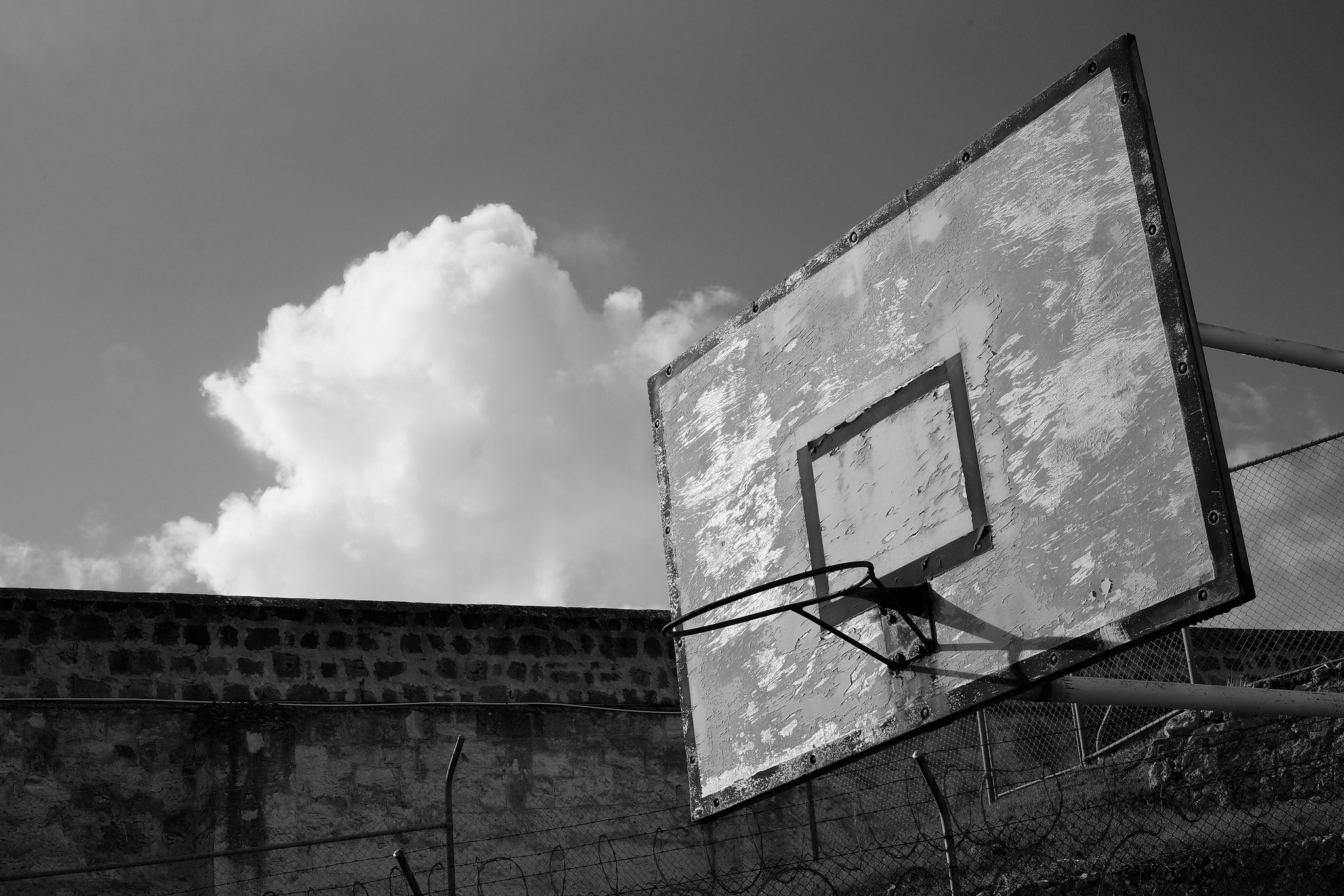 Old basketball hoop against a cloudy sky HD Wallpaper
