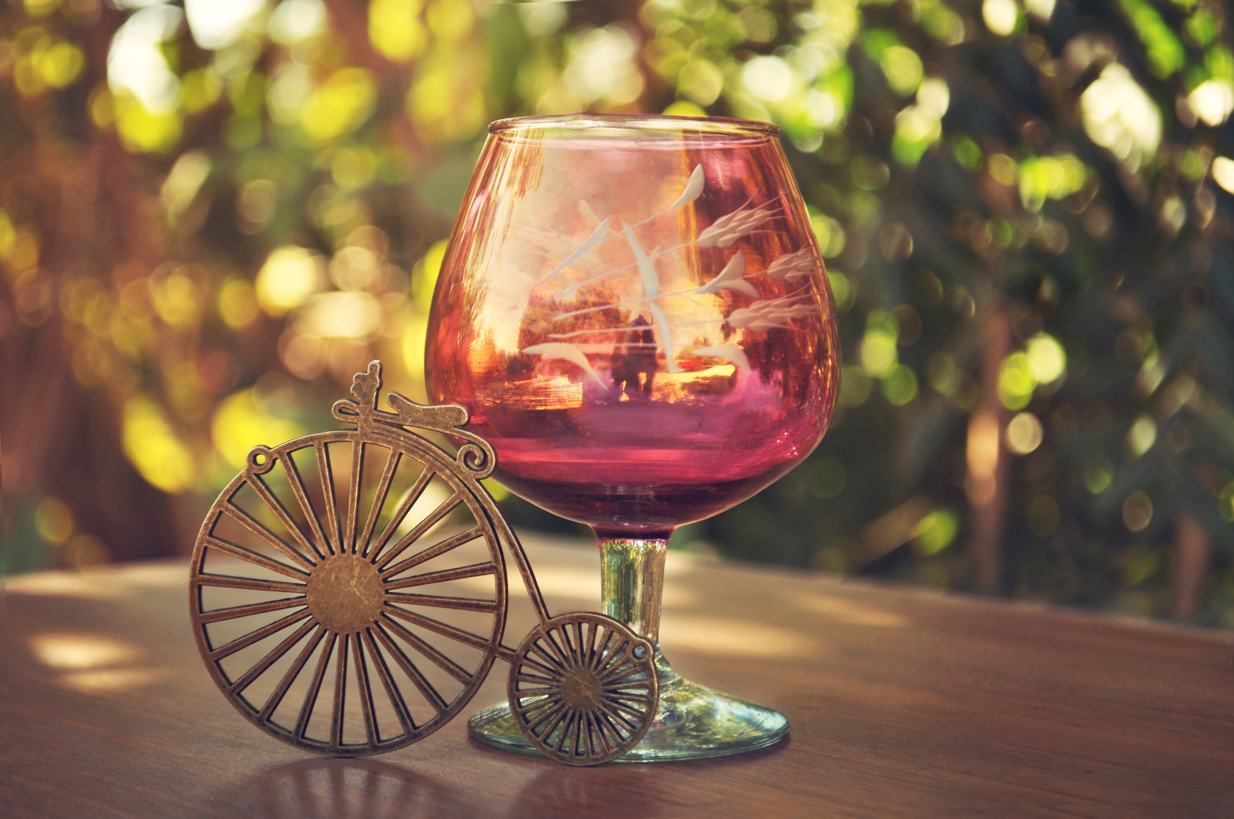 Glass with a miniature bicycle HD Wallpaper