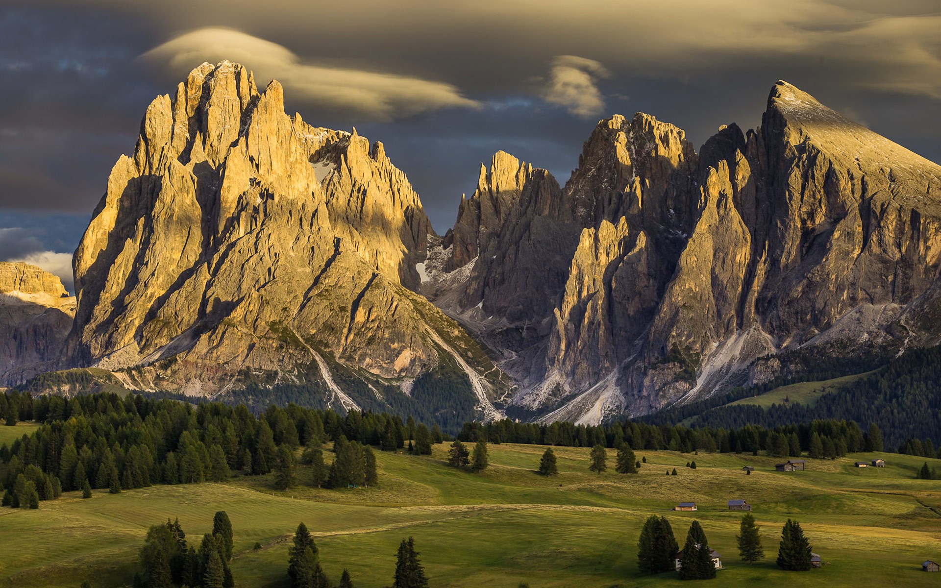 Golden mountain peaks at sunset over a green meadow HD Wallpaper