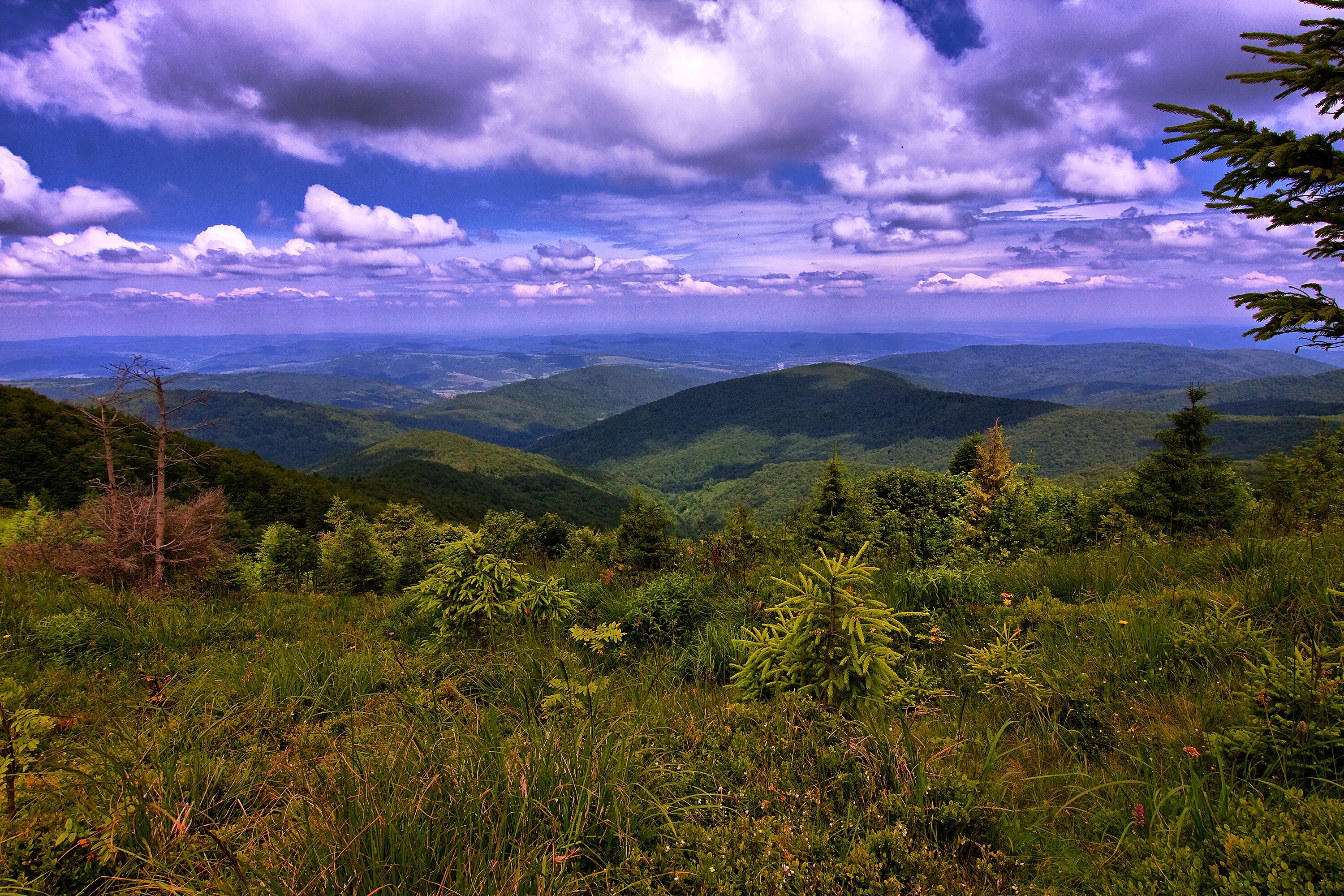 Mountain landscape with rolling hills and clouds HD Wallpaper