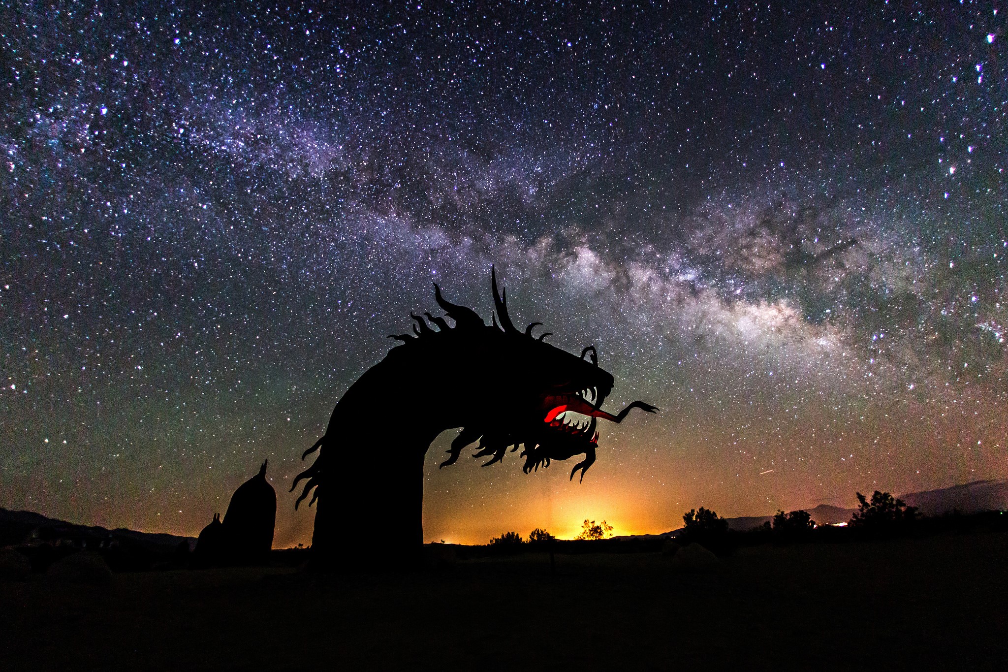 Dragon sculpture silhouetted against the Milky Way HD Wallpaper