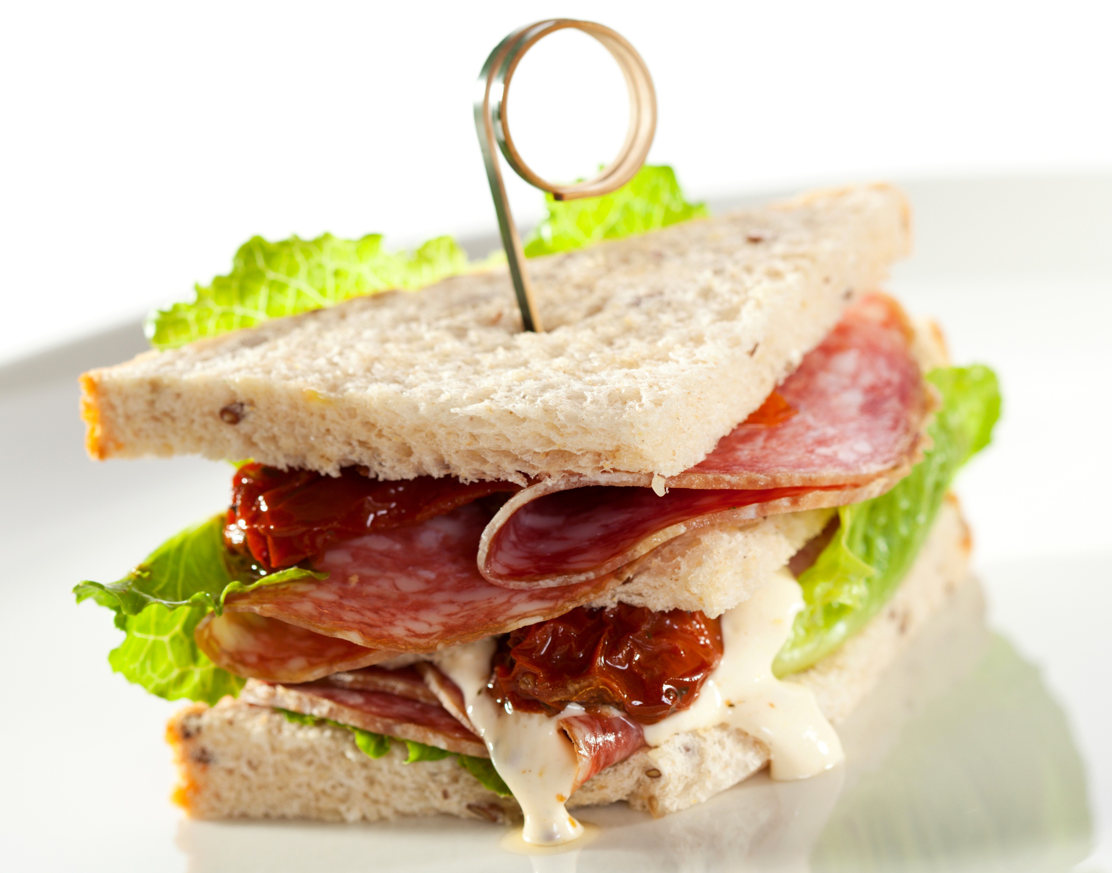 Sandwich with salami, sun-dried tomatoes, and lettuce HD Wallpaper