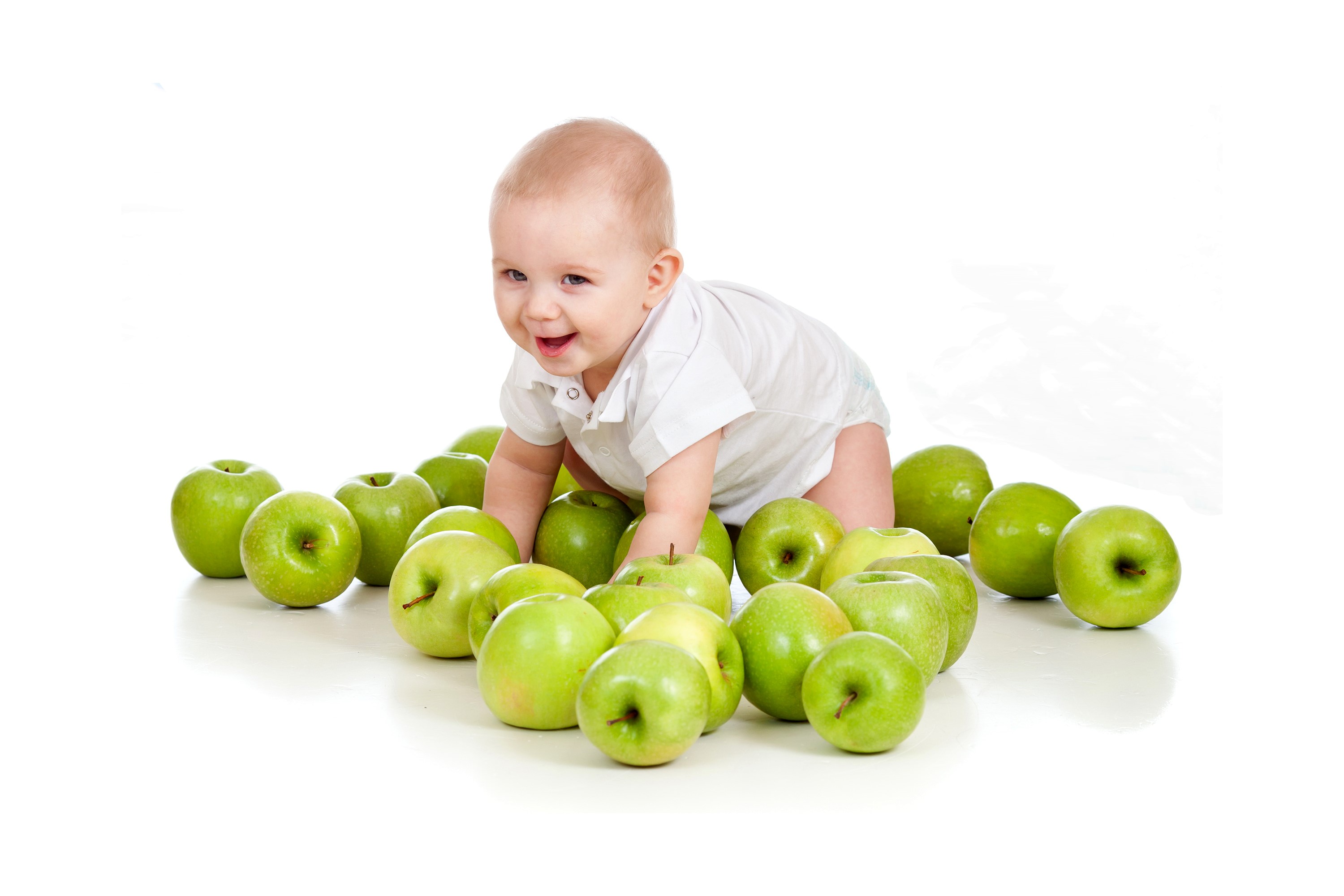 Baby boy crawling among green apples HD Wallpaper