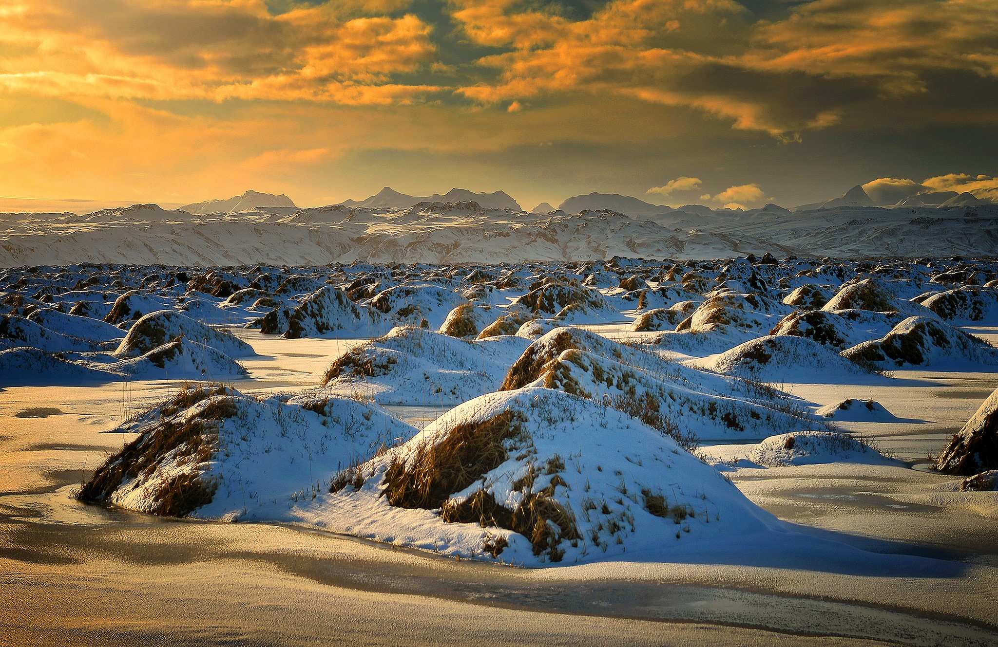Snowy landscape with mountains and dramatic clouds at sunset HD Wallpaper