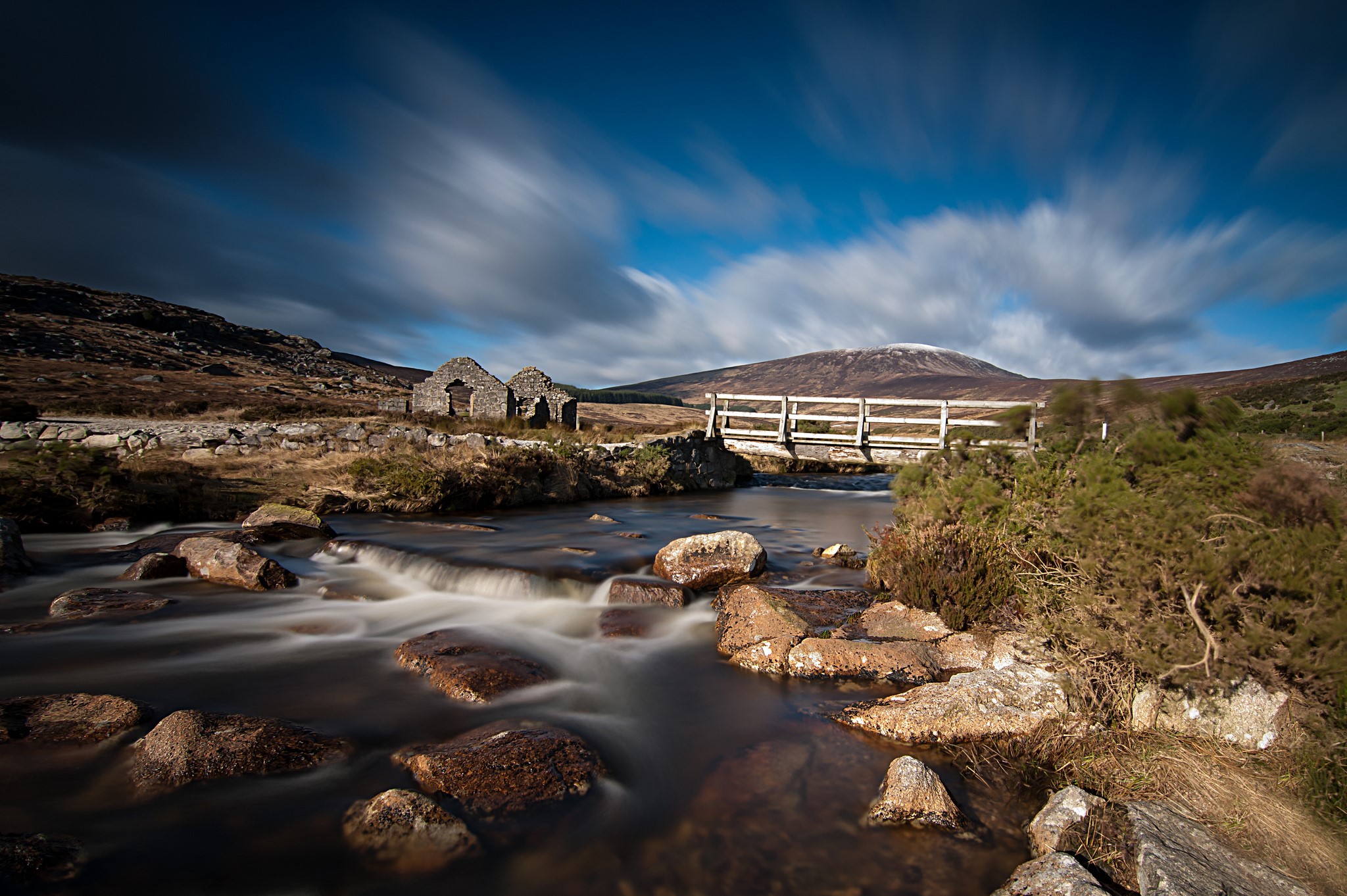 Ruins and bridge over a river with a mountain in the background HD Wallpaper