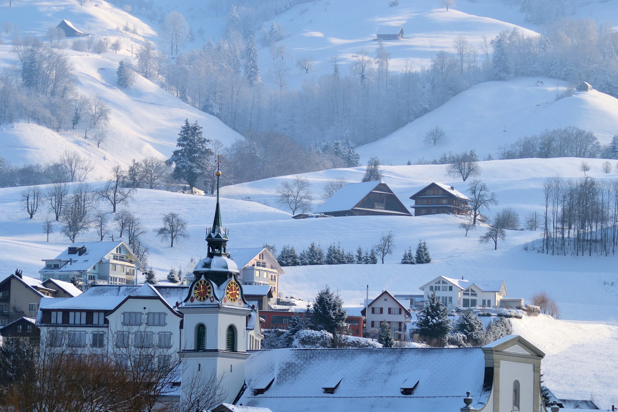 Snowy village with church tower and mountains HD Wallpaper