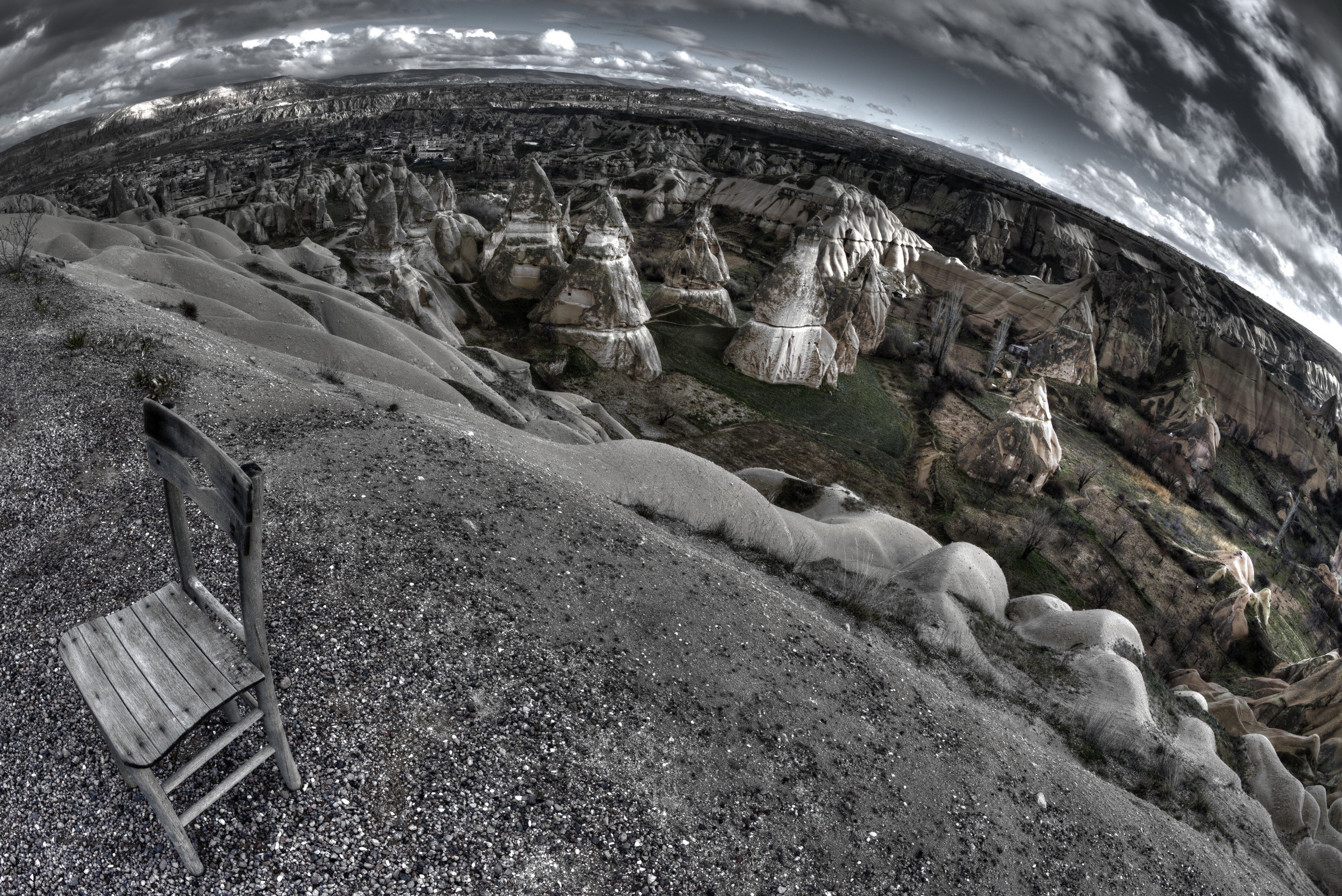 Chair overlooking rocky landscape with hoodoos HD Wallpaper