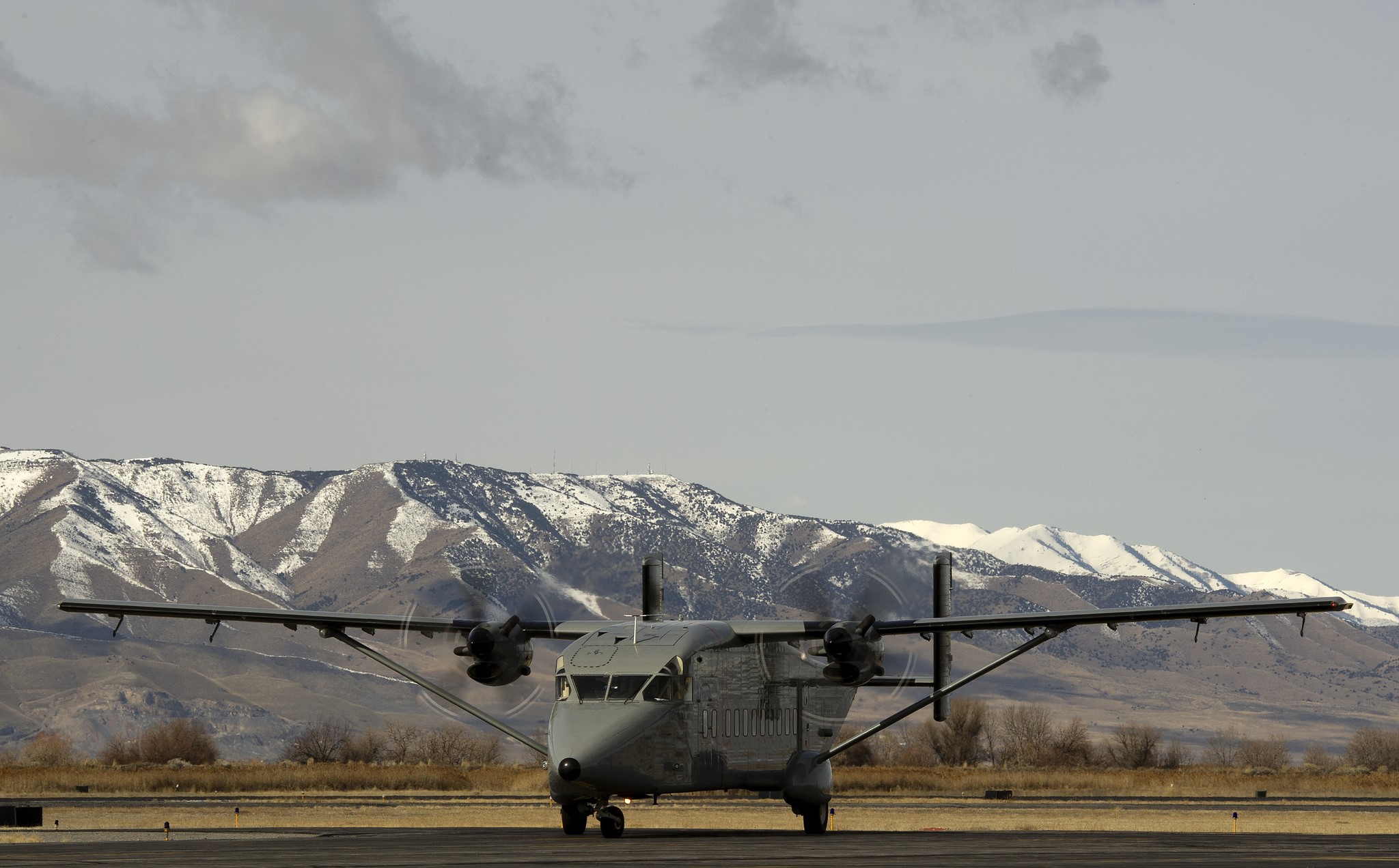Short C-23 Sherpa airplane on tarmac with mountains HD Wallpaper