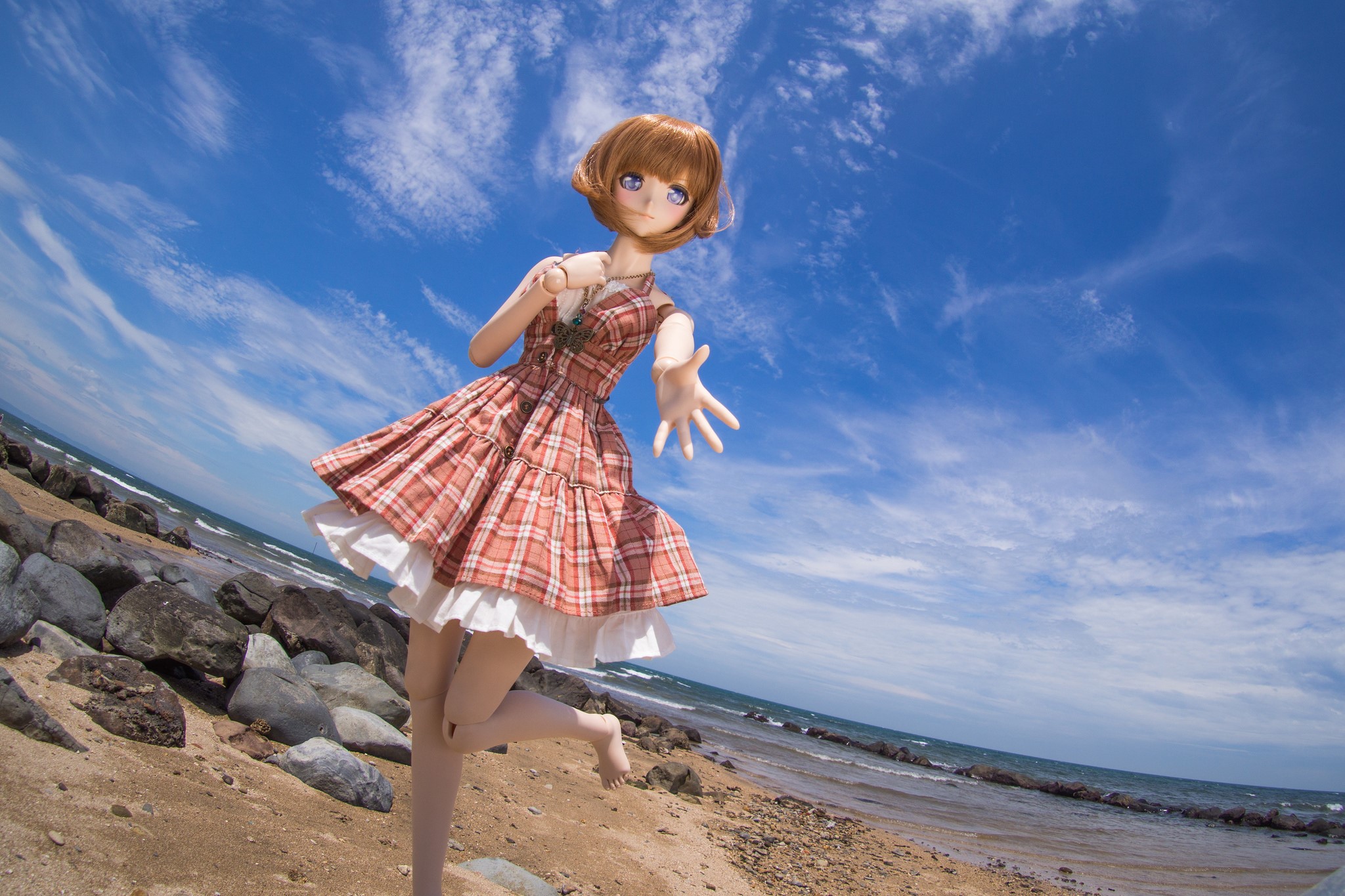 Doll in a Plaid Dress on a Beach HD Wallpaper