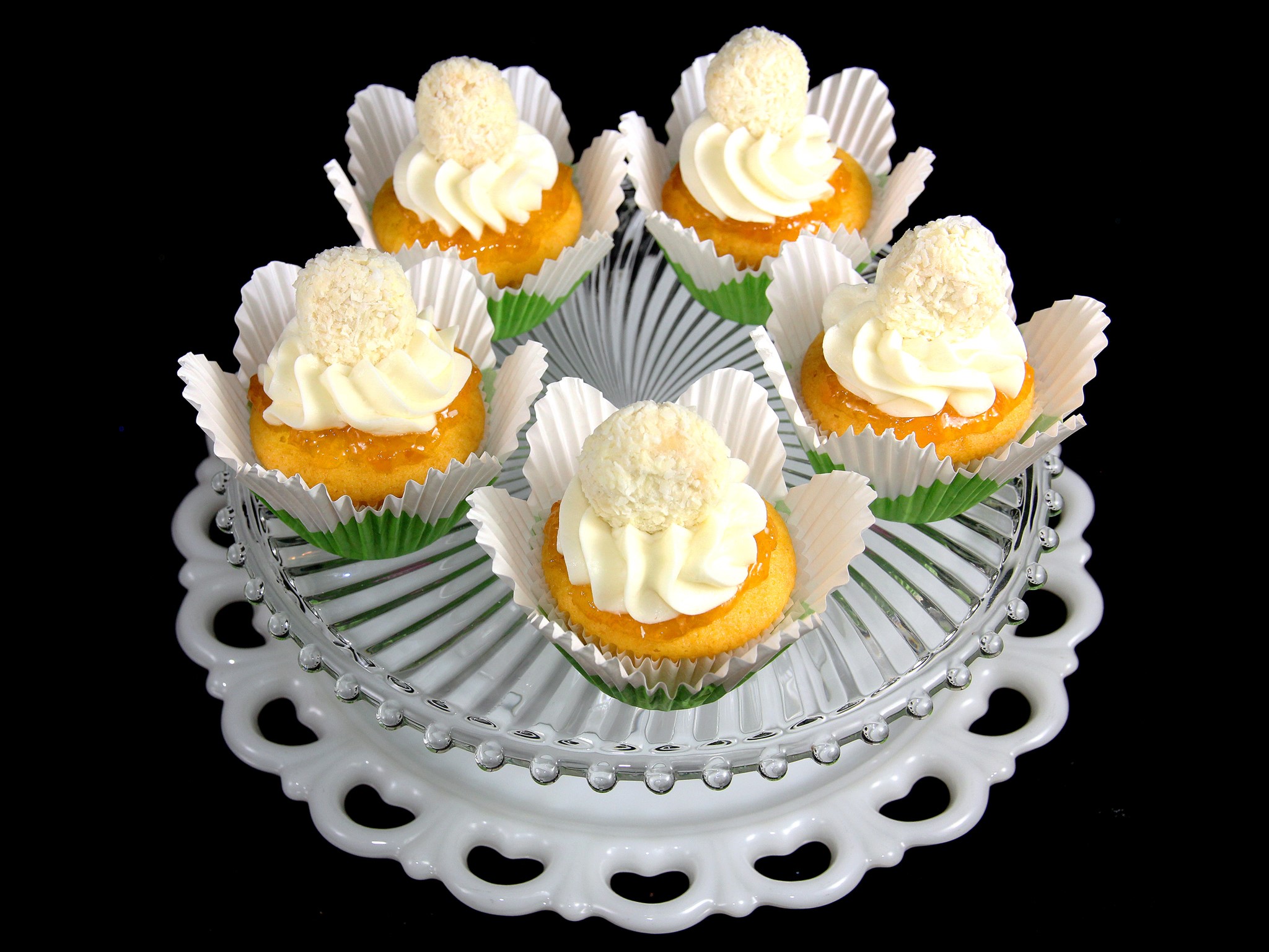 Mini cakes with frosting and coconut on a cake stand HD Wallpaper