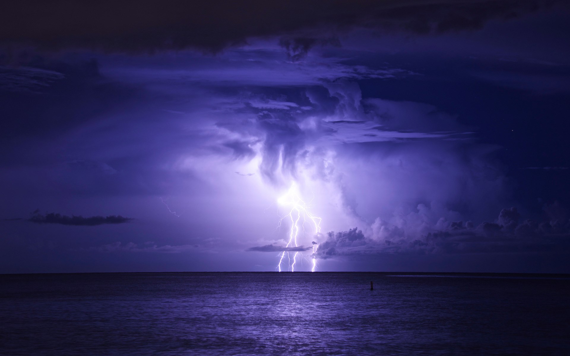 Lightning strikes over the ocean during a storm HD Wallpaper
