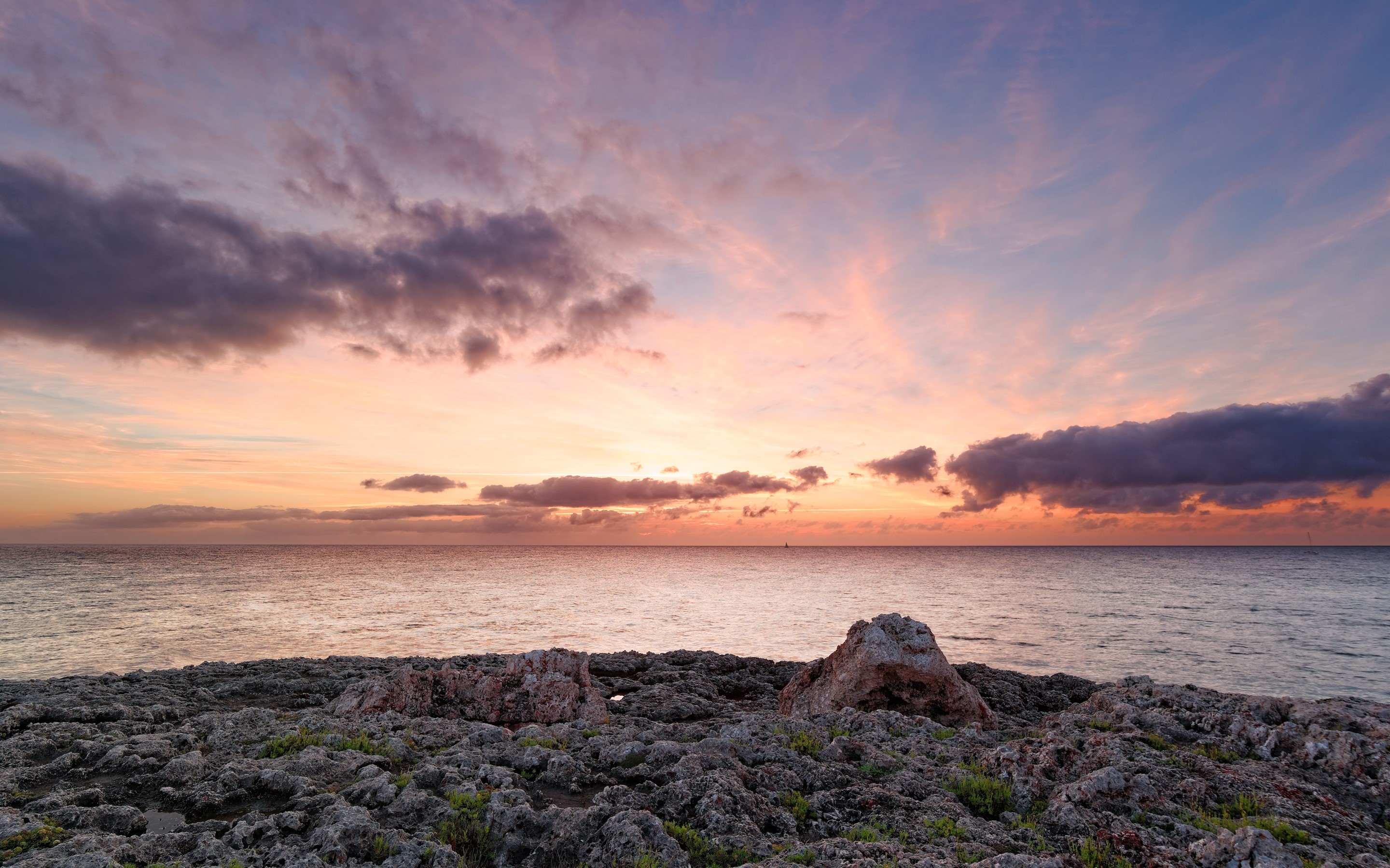 Rocky coast at sunrise over the sea in Balearic Islands HD Wallpaper