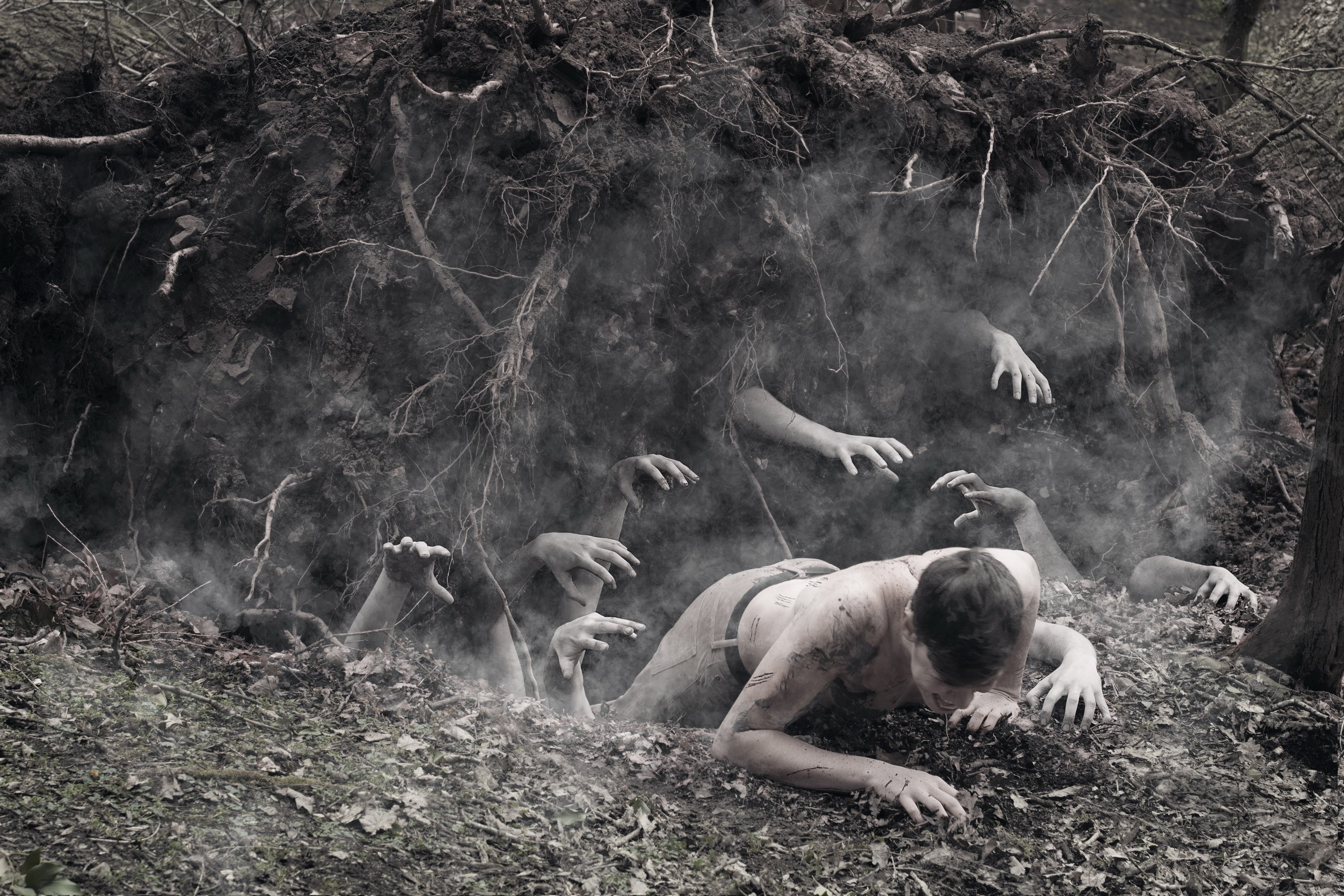 Man crawling from earth with hands emerging HD Wallpaper