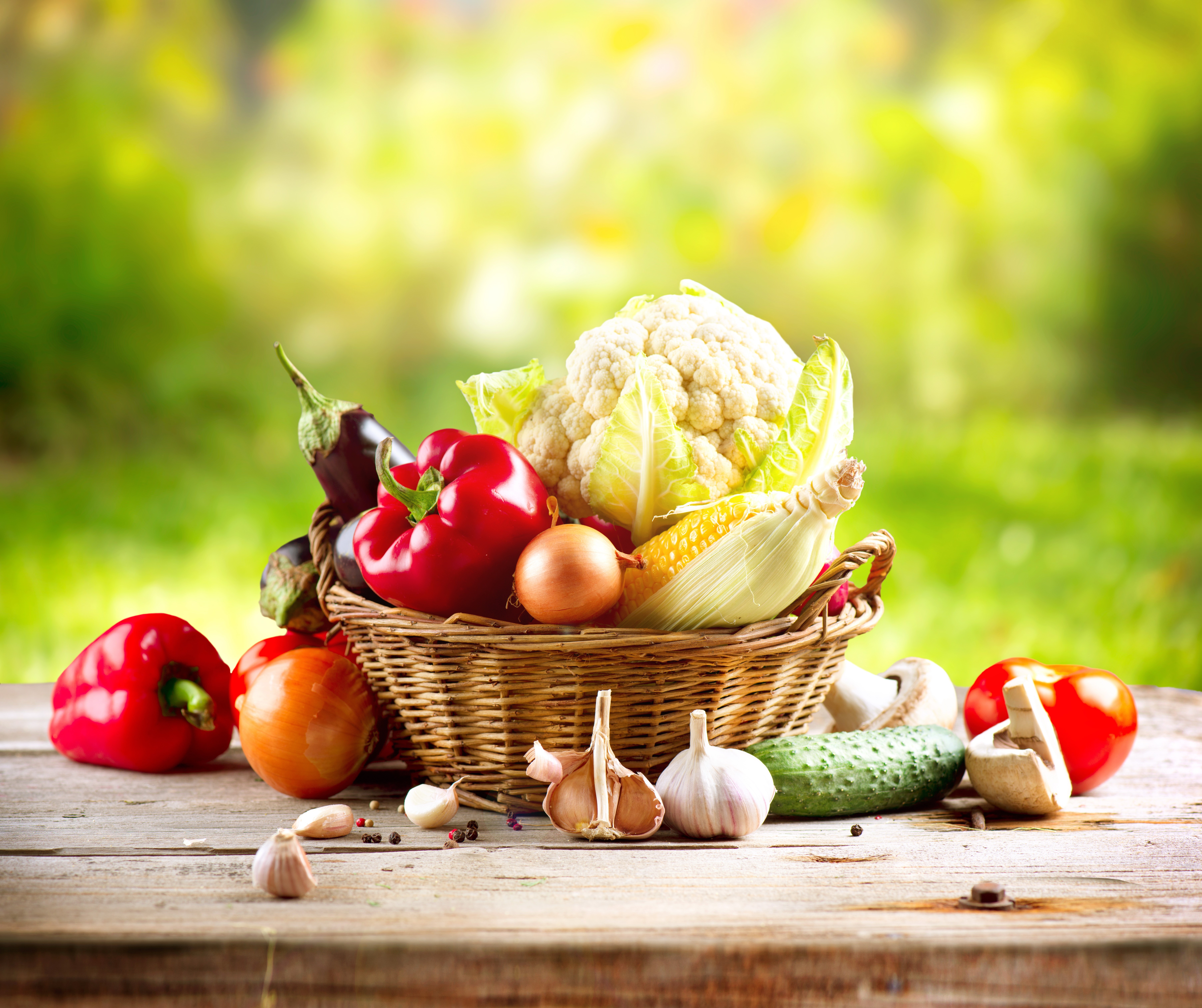 Vegetables in a wicker basket on a wooden table HD Wallpaper