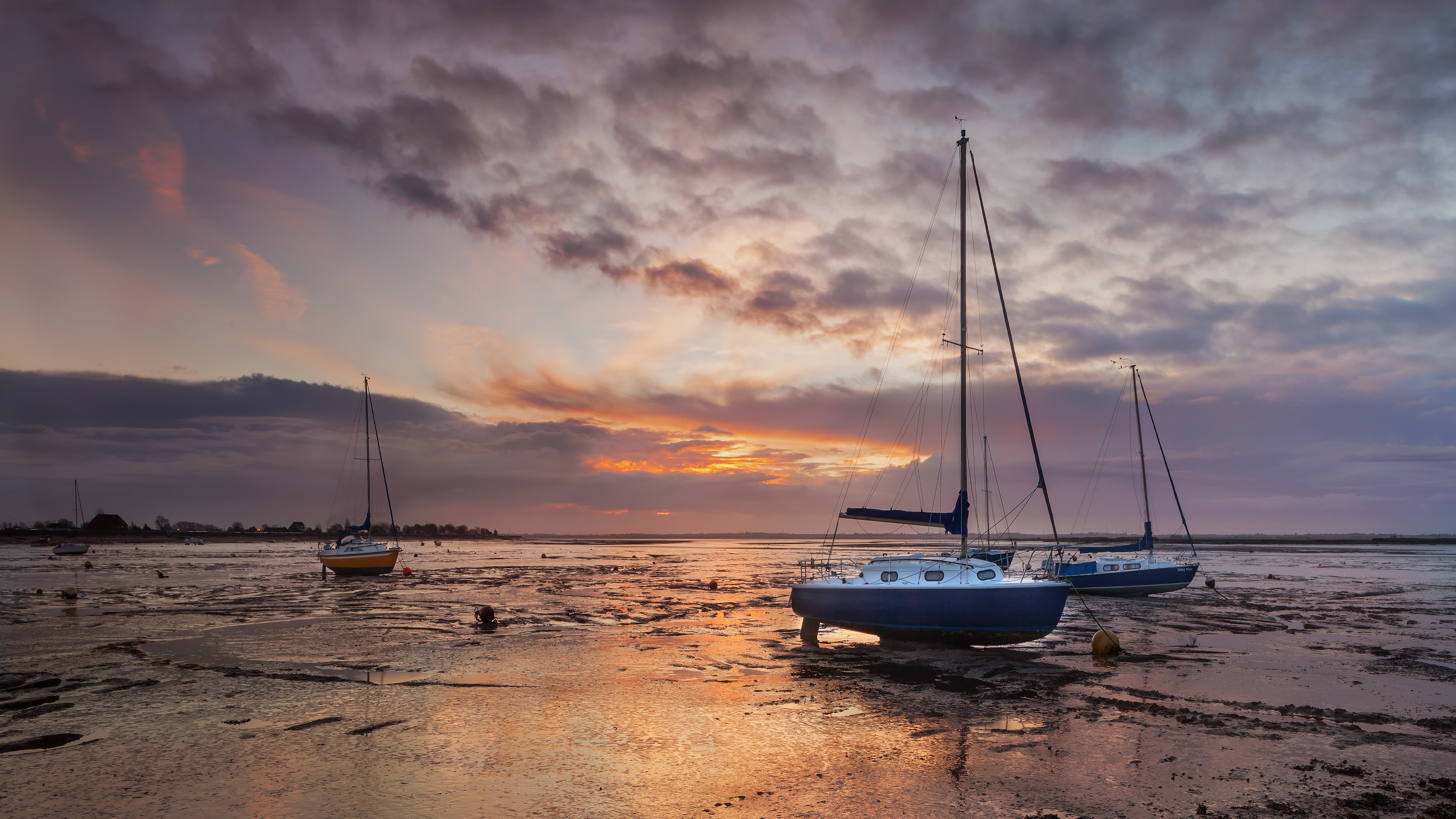 Sailboats grounded on mudflats at sunset HD Wallpaper