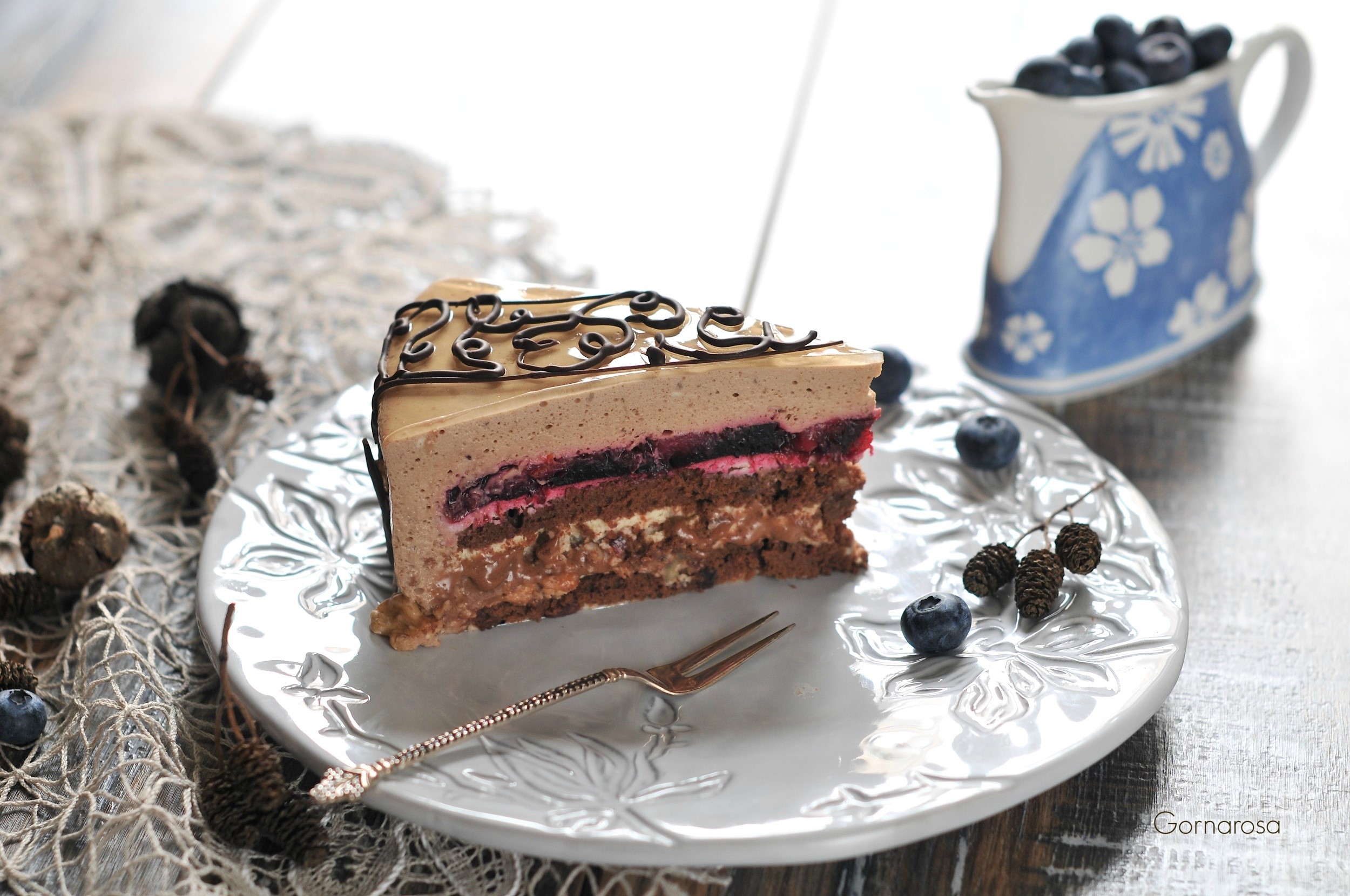 Slice of layered chocolate cake with blueberries HD Wallpaper