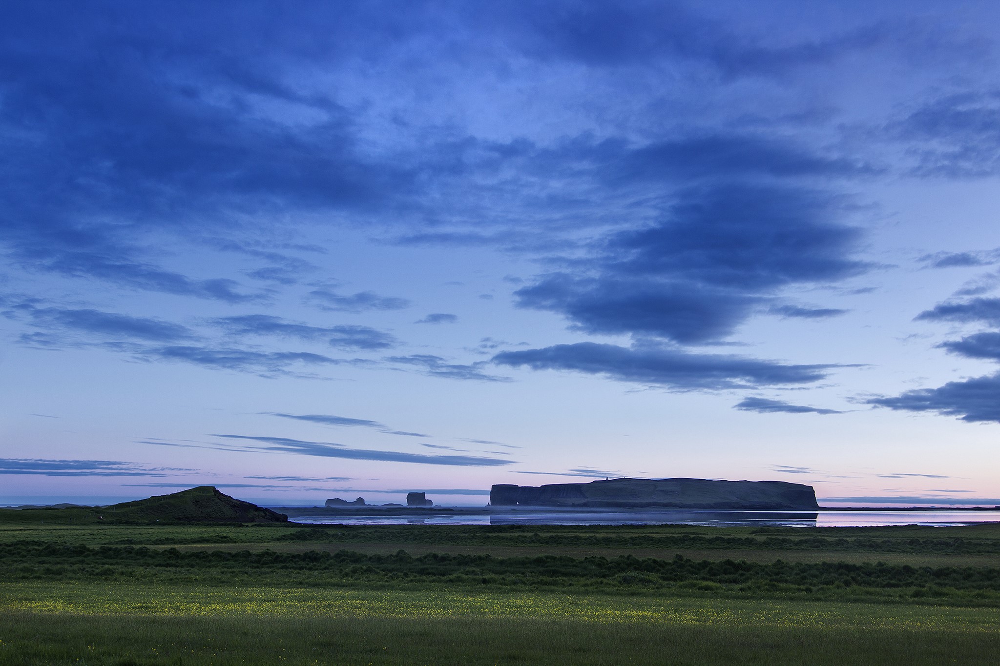 Dramatic clouds over a coastal landscape with rock formations HD Wallpaper