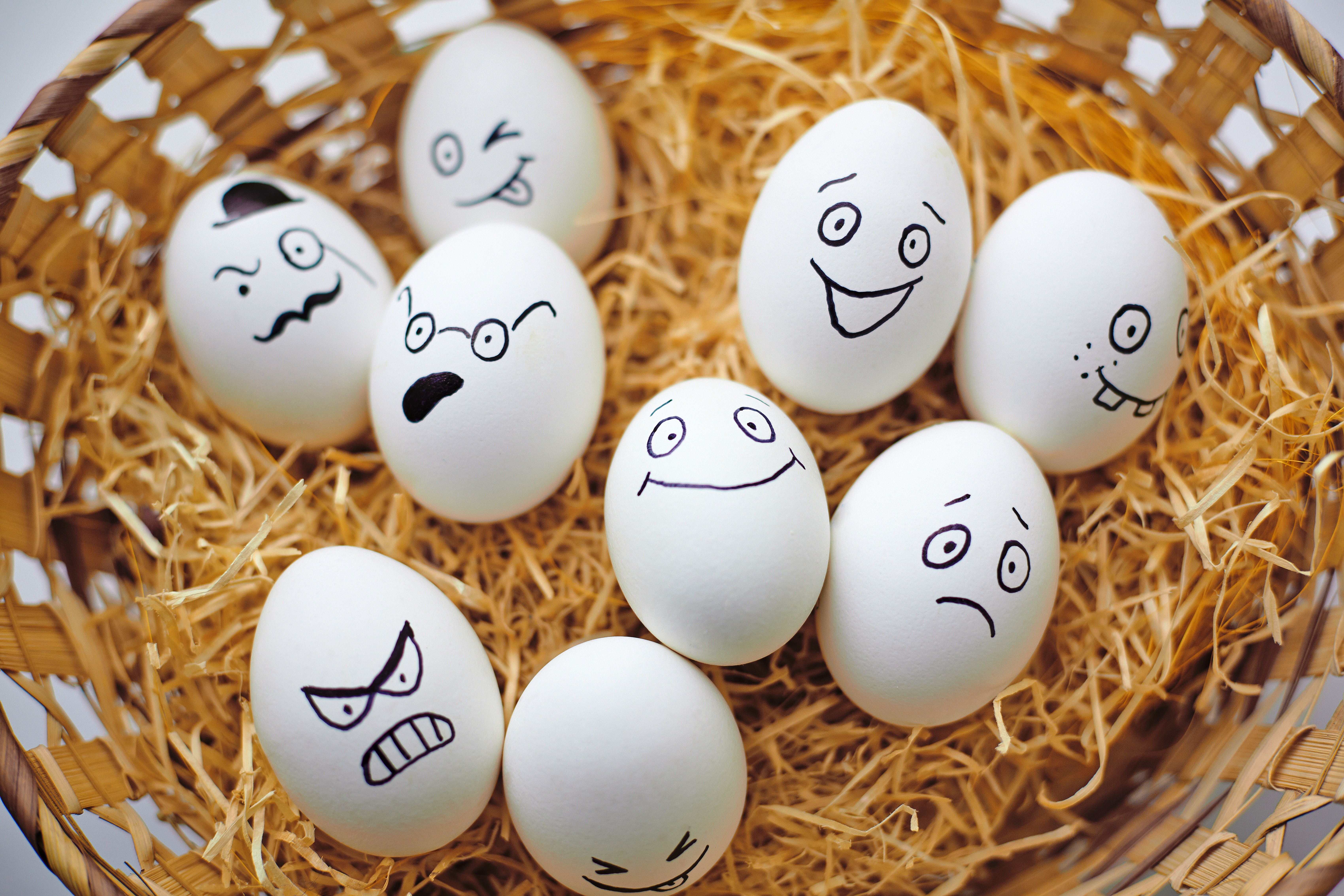 Easter eggs with faces in a wicker basket HD Wallpaper