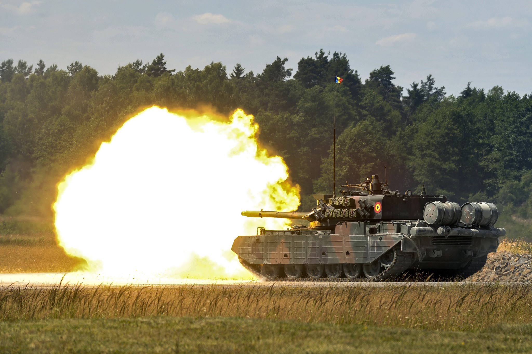 Tank firing a projectile with a large explosion HD Wallpaper