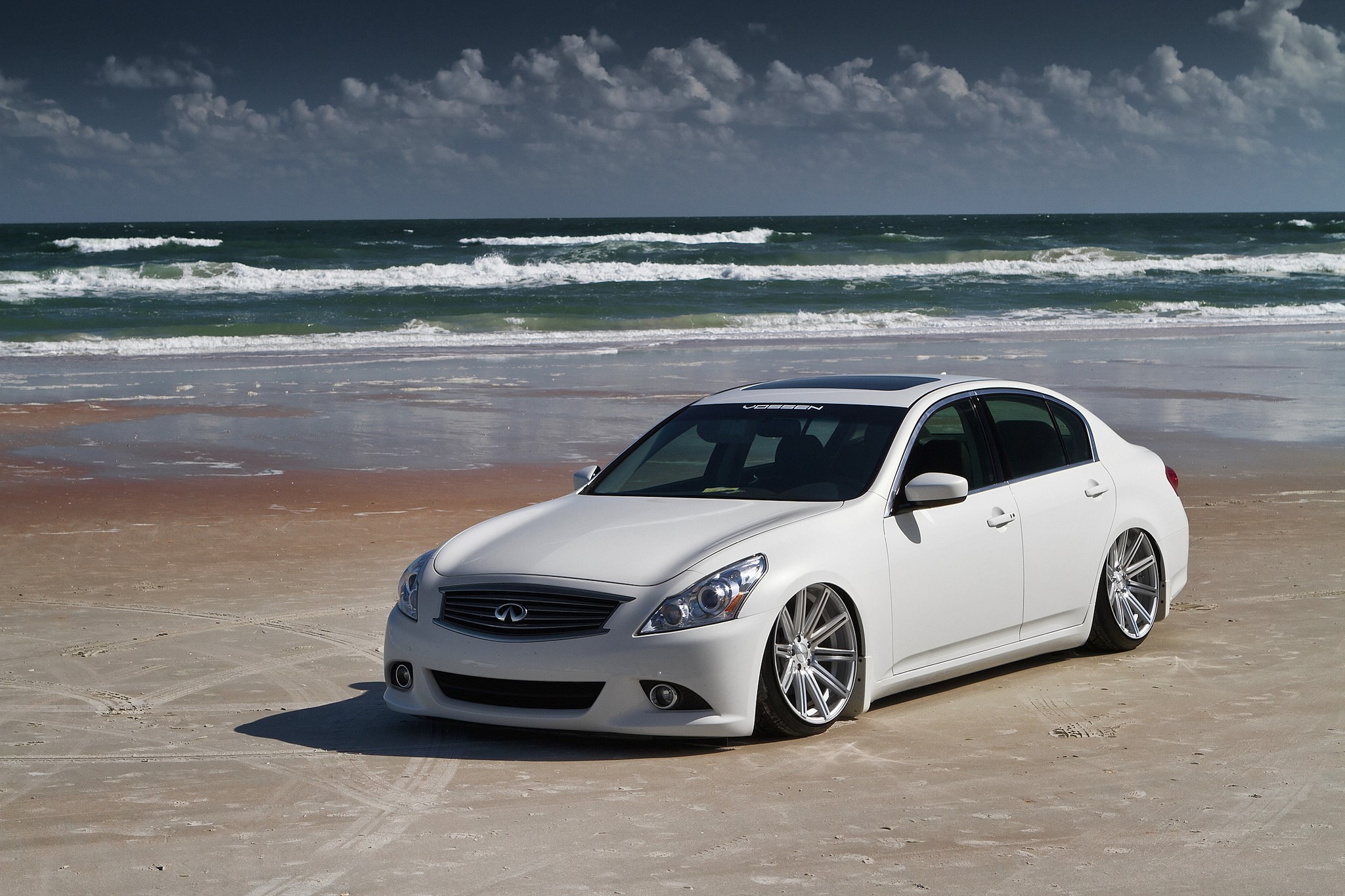 White Infiniti Sedan on a Beach HD Wallpaper