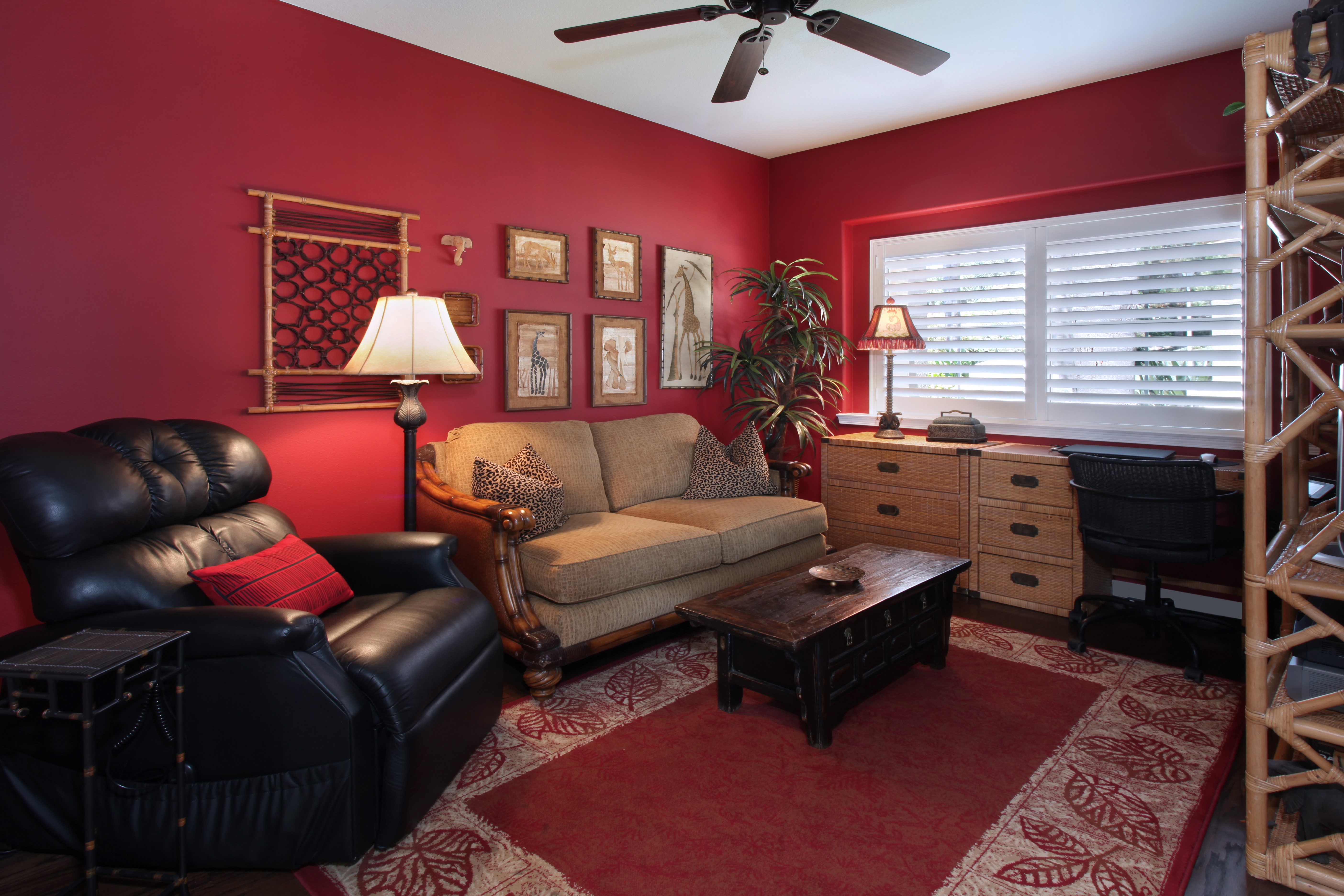 Living room with red walls, sofa, armchair, and desk HD Wallpaper