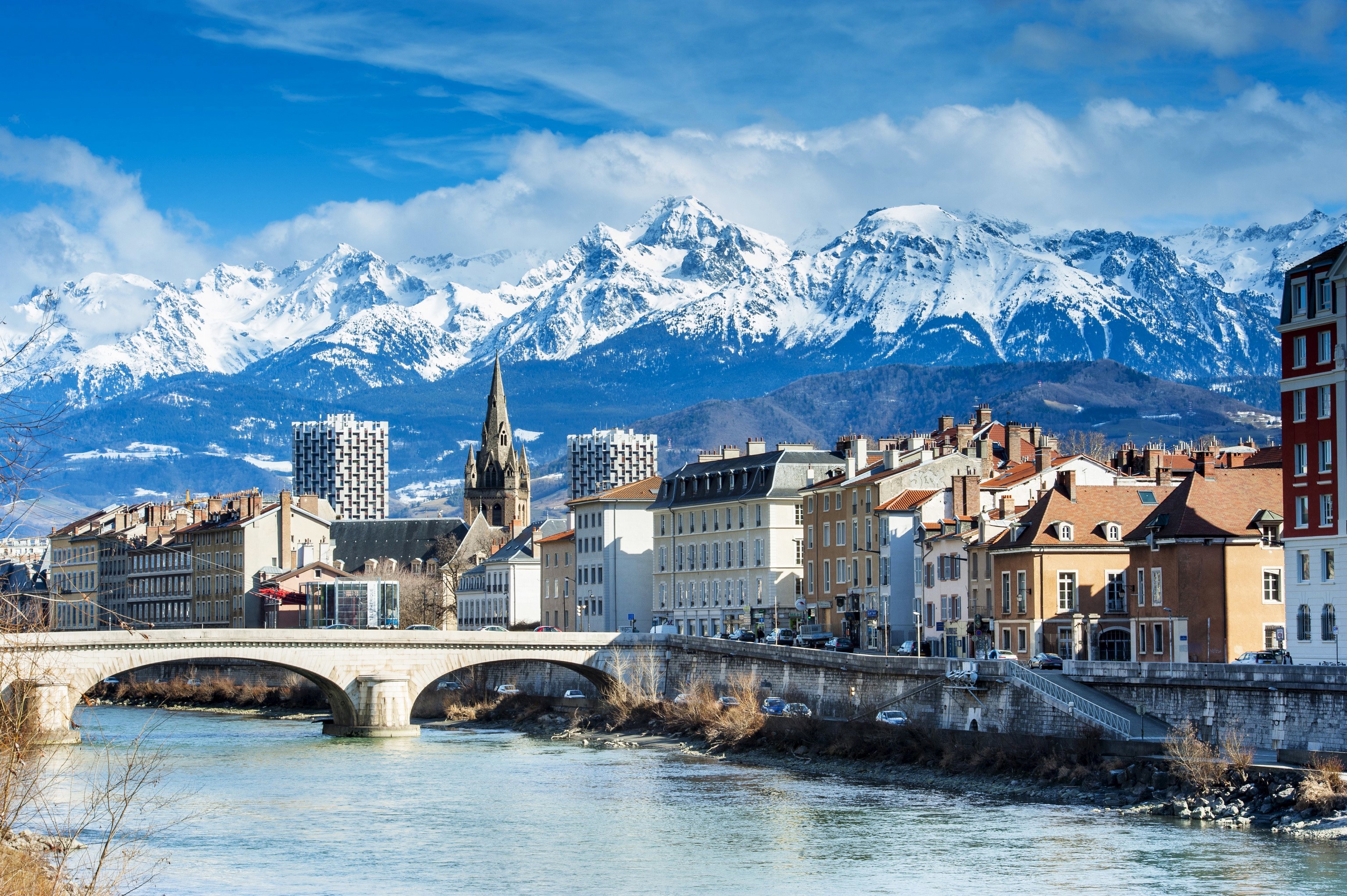 Grenoble, France with snow-capped mountains and river HD Wallpaper