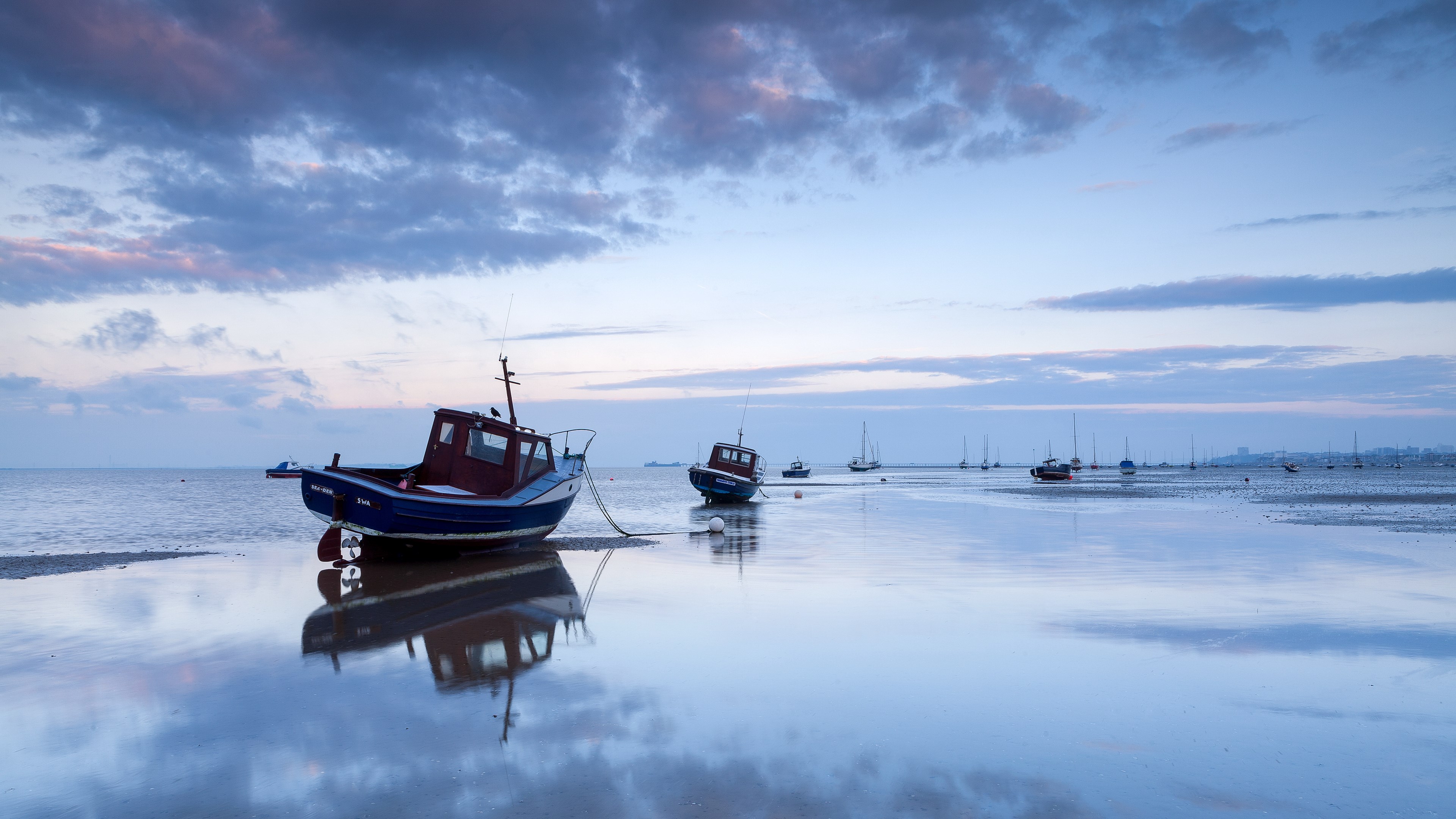 Boats on a calm sea at dusk with reflections HD Wallpaper