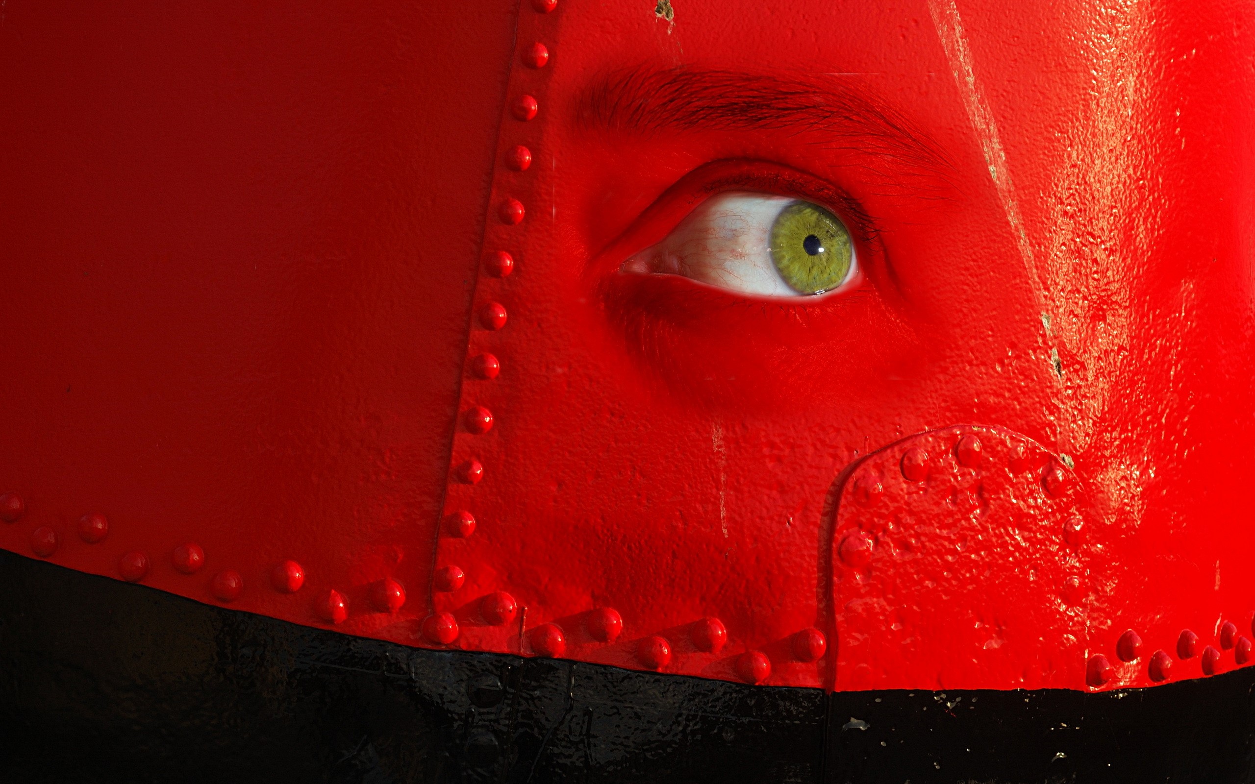 Close-up of a green eye on a red surface HD Wallpaper