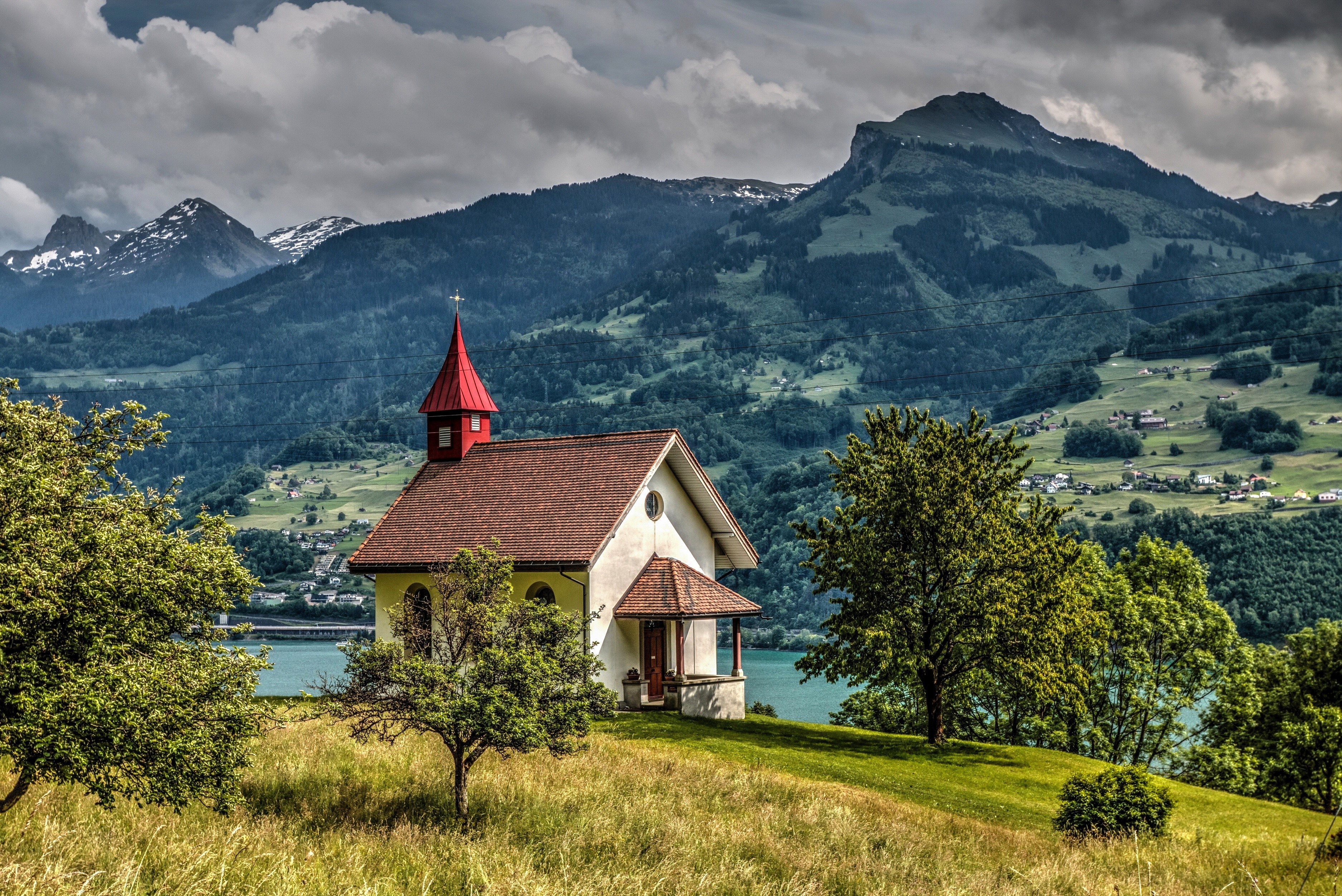 Chapel in the Swiss Alps with Mountains and Lake HD Wallpaper
