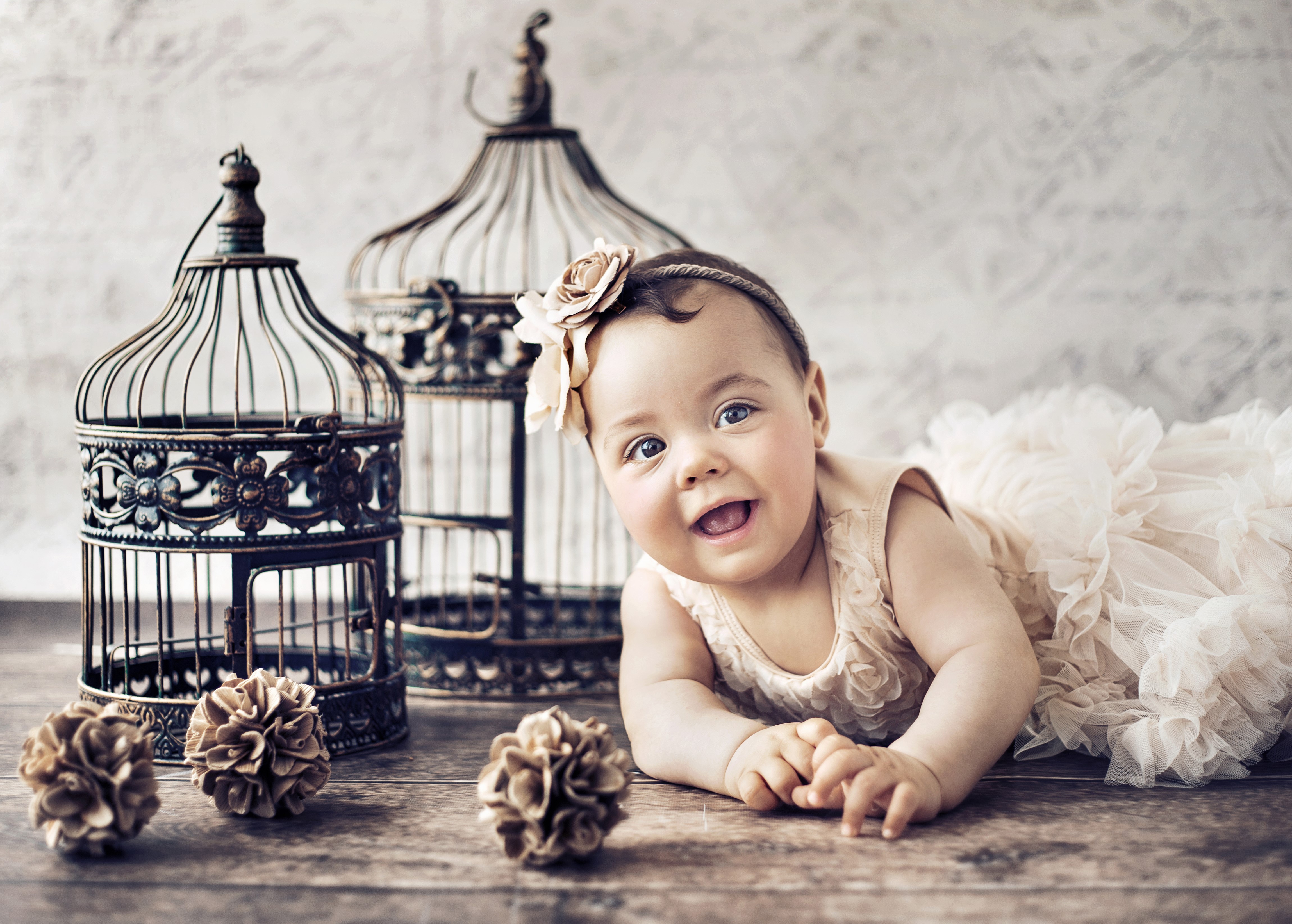 Baby girl in a dress with birdcages HD Wallpaper