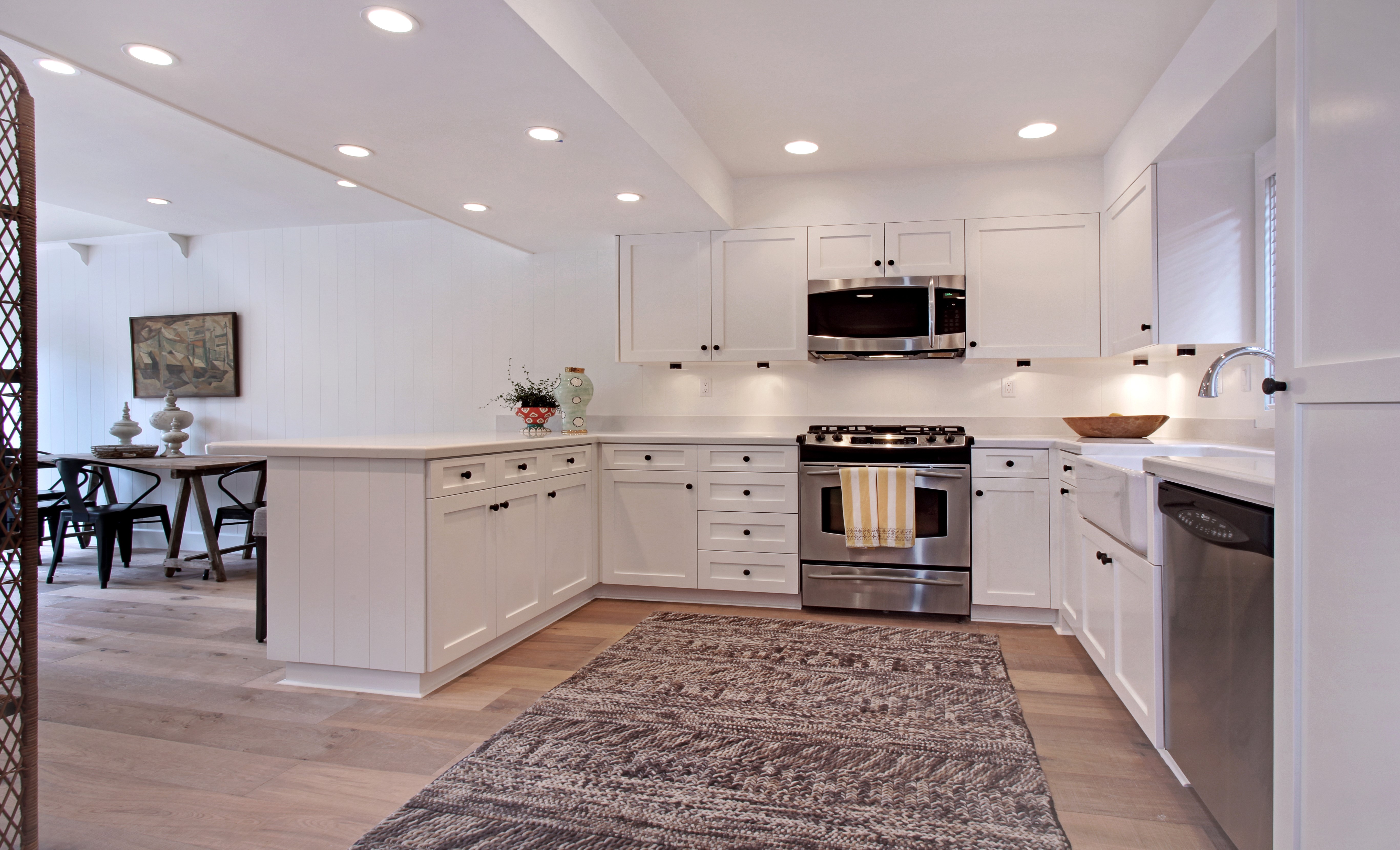Modern white kitchen with island and dining area HD Wallpaper