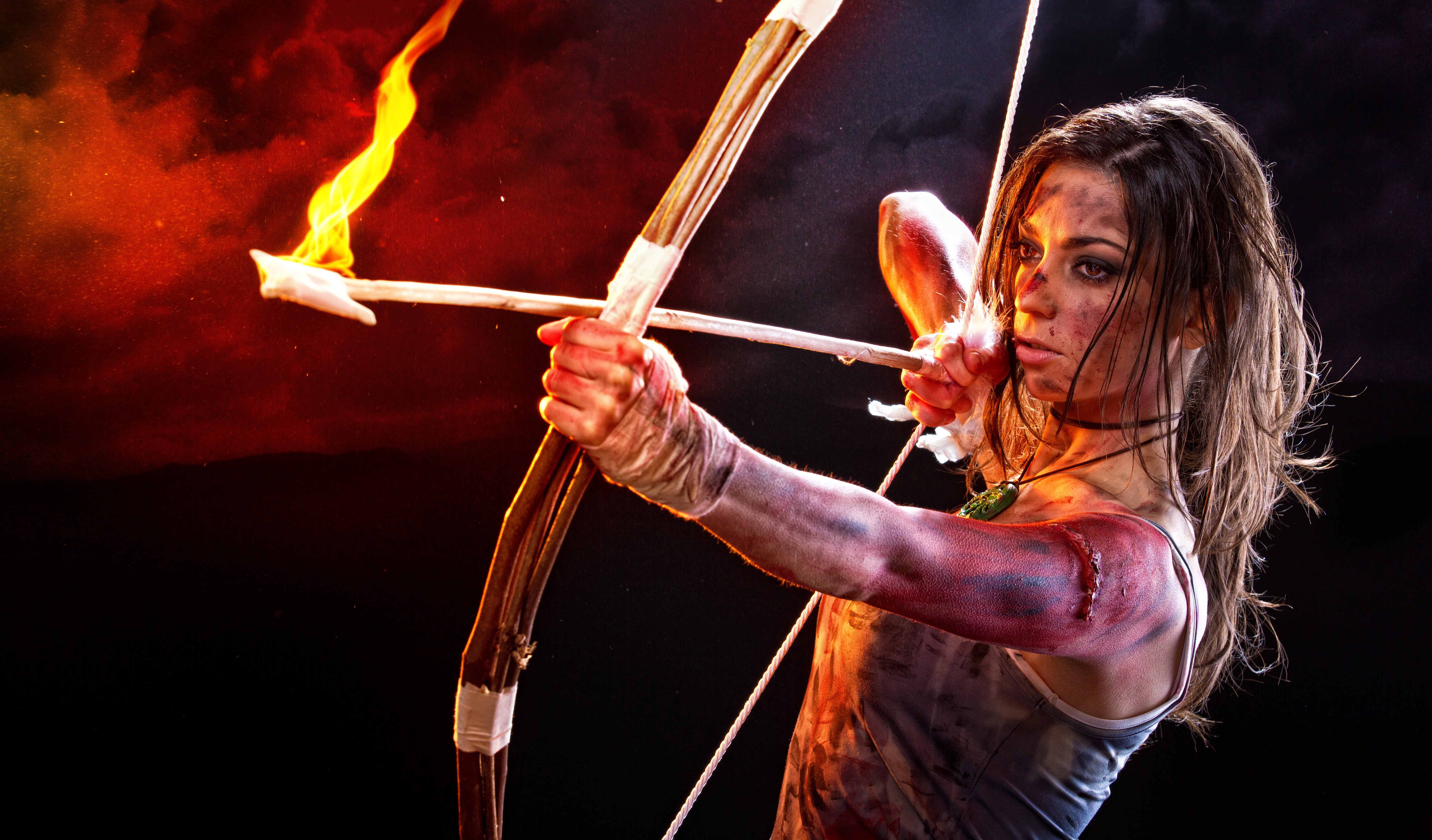 Lara Croft from Tomb Raider 2013 with flaming arrow HD Wallpaper
