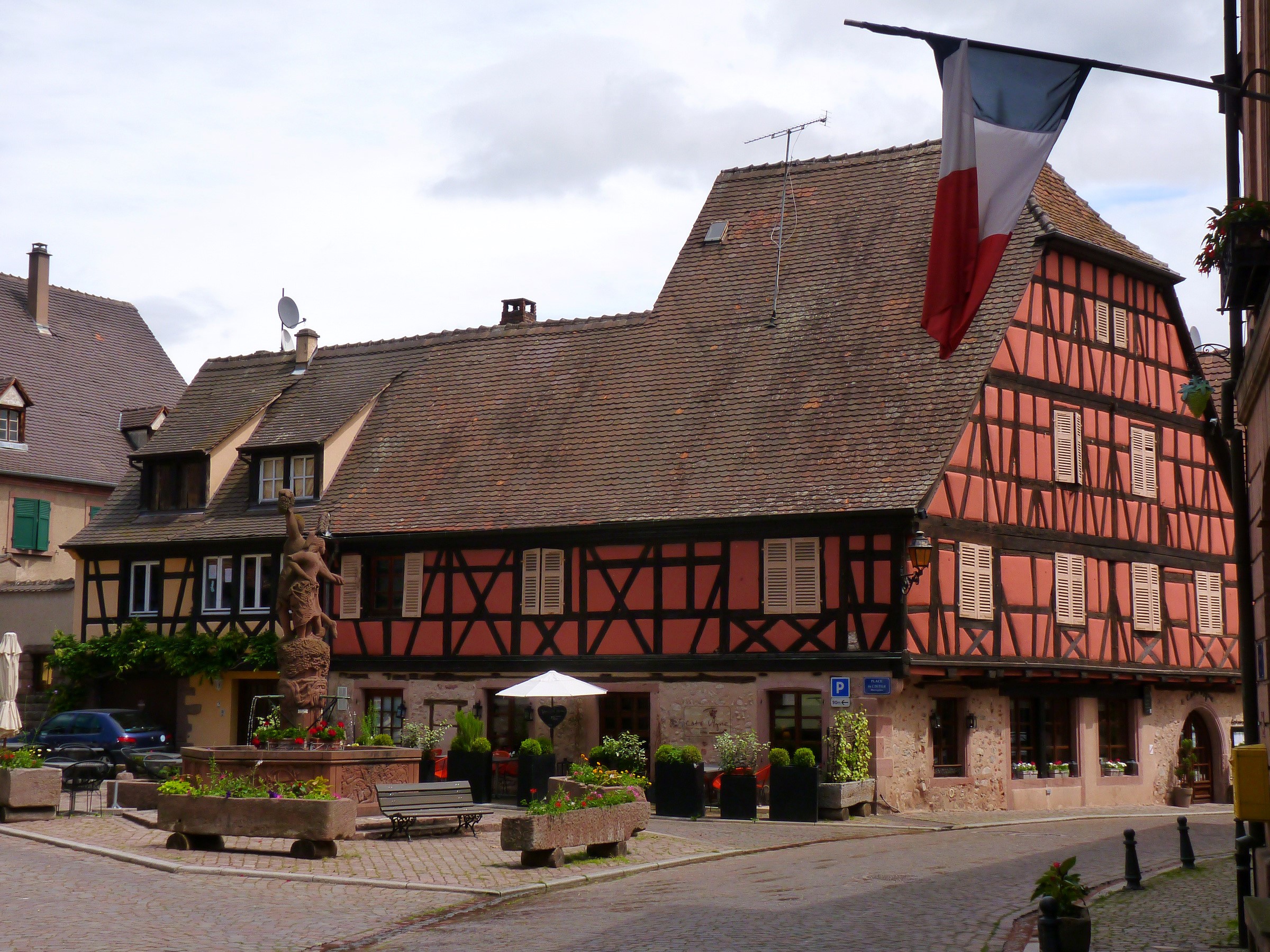 Half-timbered houses and fountain in Kientzheim, France HD Wallpaper