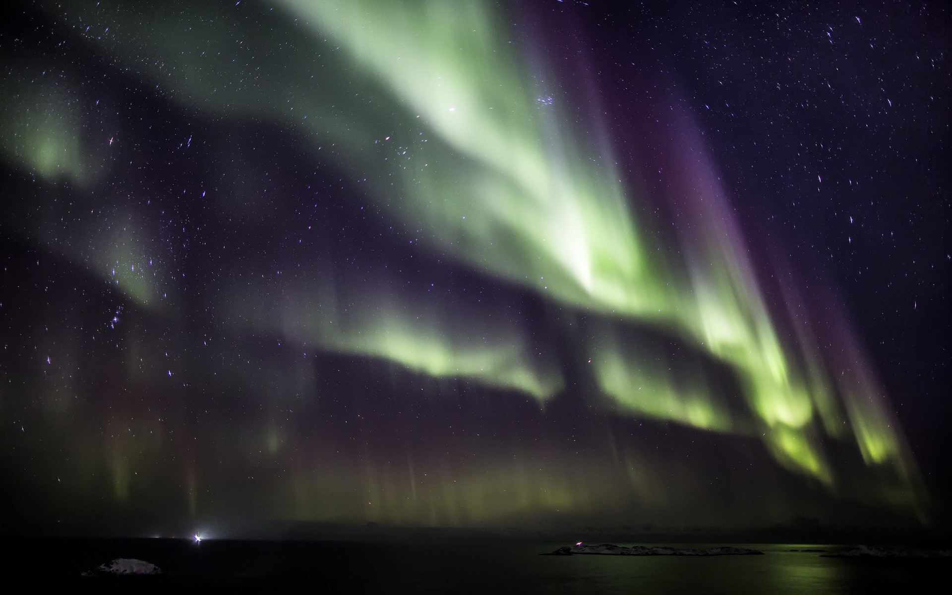 Aurora Borealis over a dark landscape and starry sky HD Wallpaper
