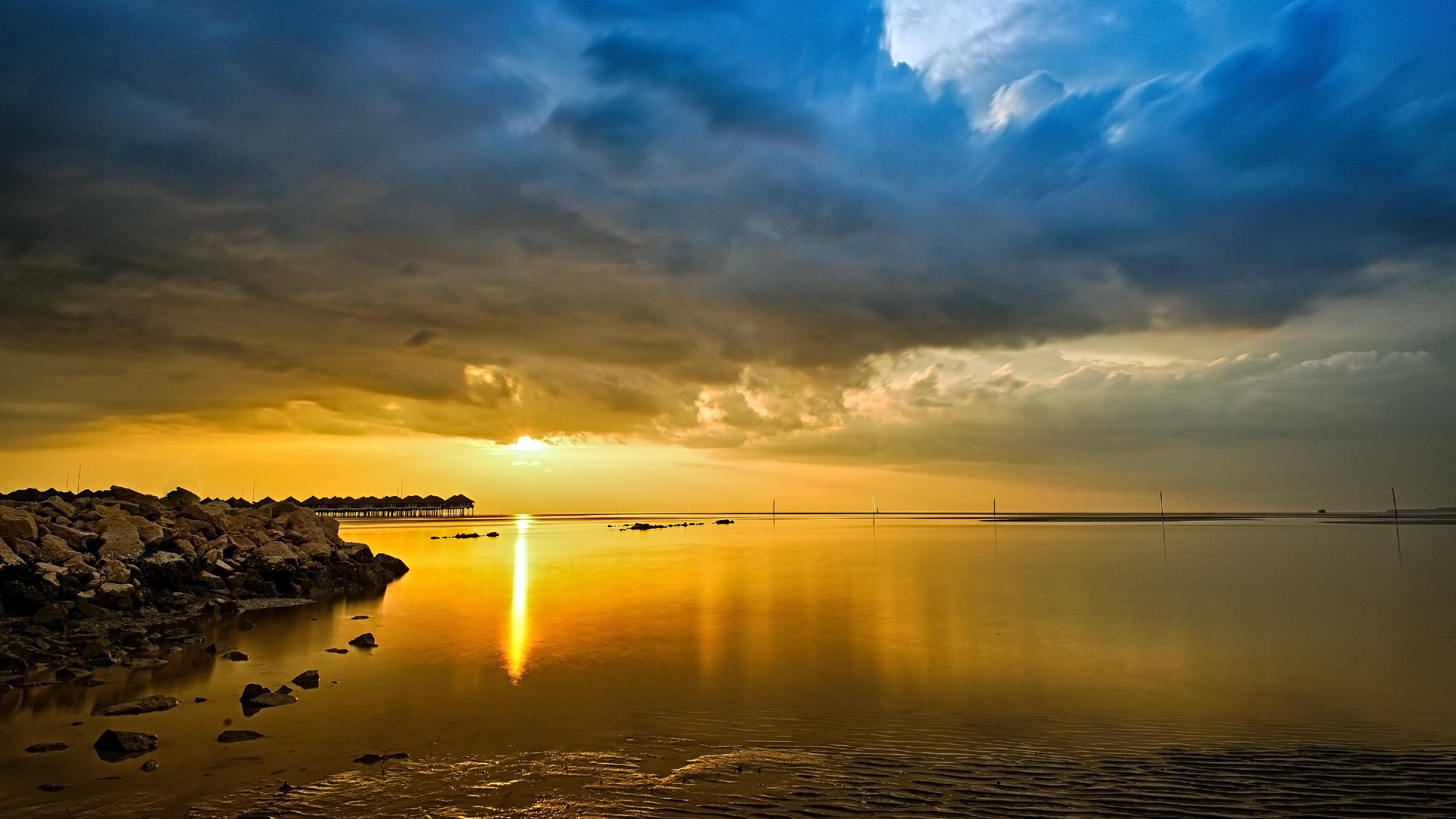 Sunset over the ocean with a rocky shore HD Wallpaper