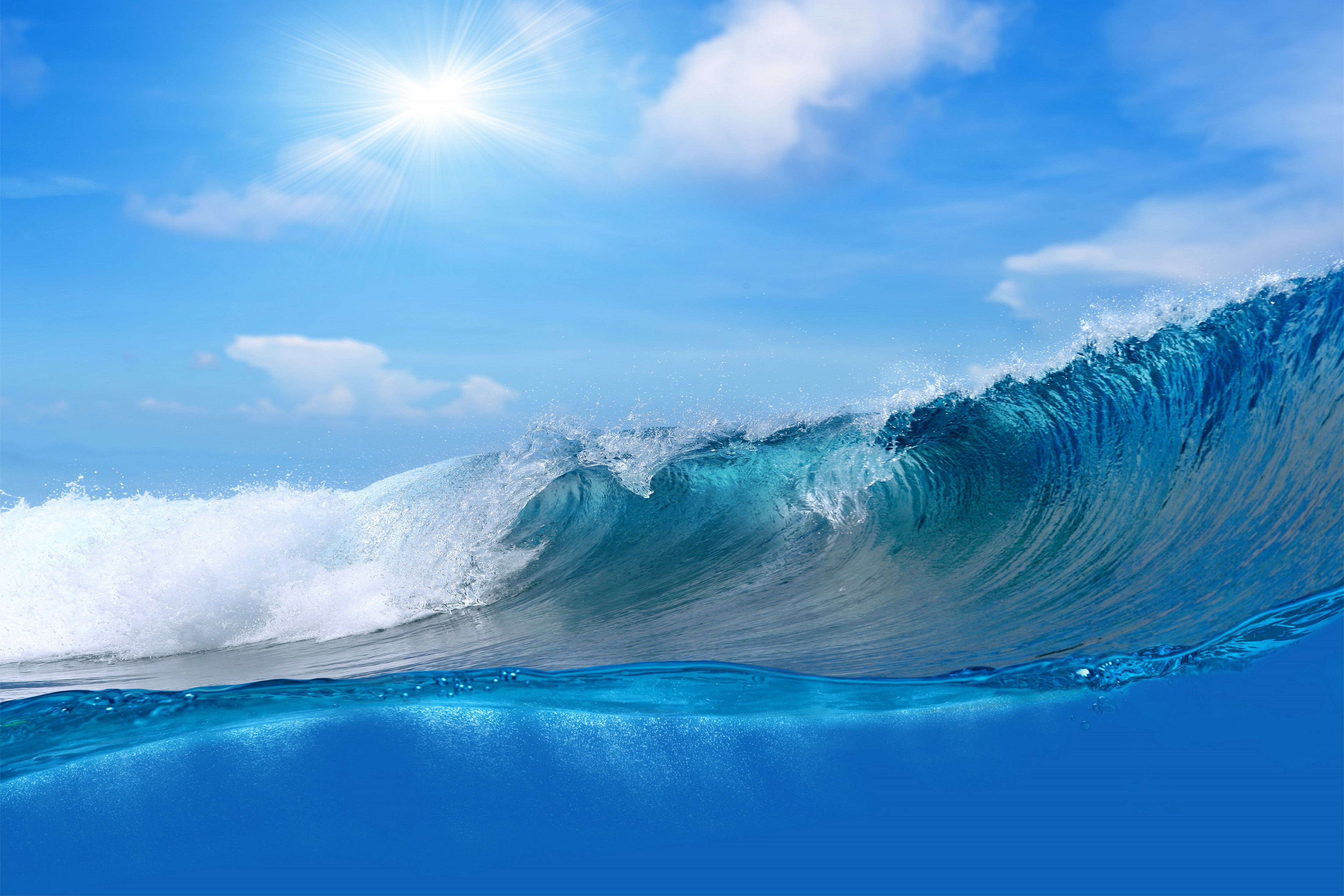 4K Ocean Wave Under Blue Sky with Sun HD Wallpaper