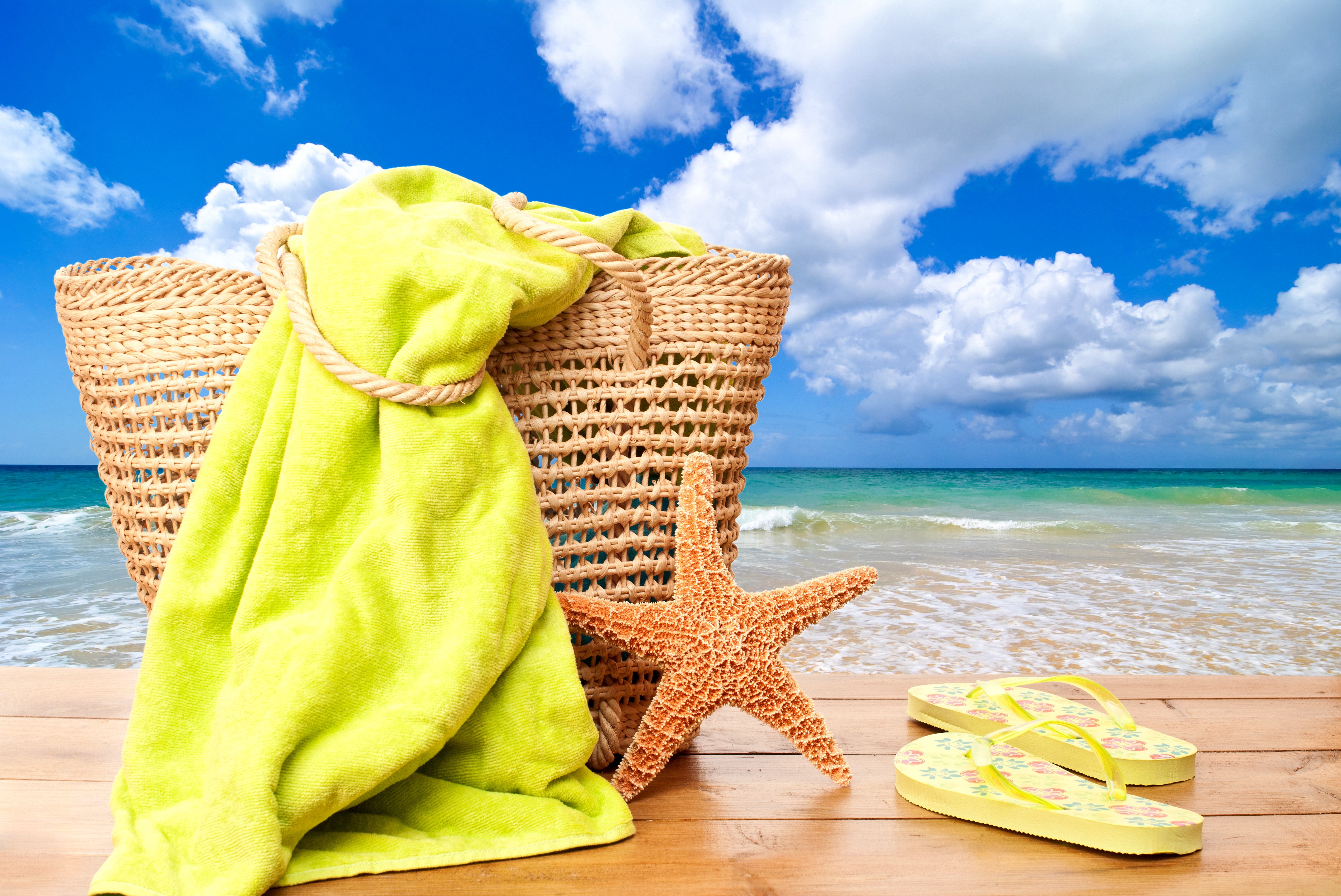 Beach scene with wicker basket, starfish, and flip-flops HD Wallpaper