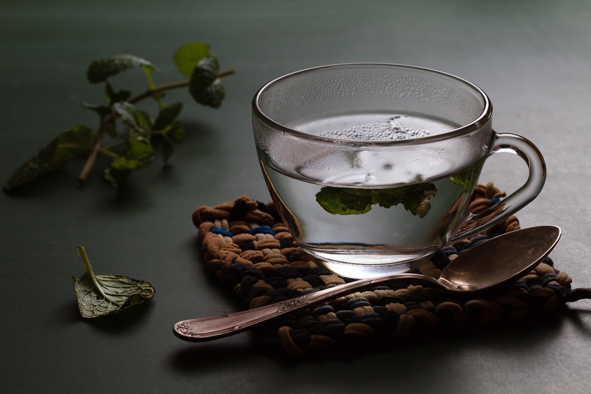 Cup of tea with mint leaves and spoon HD Wallpaper