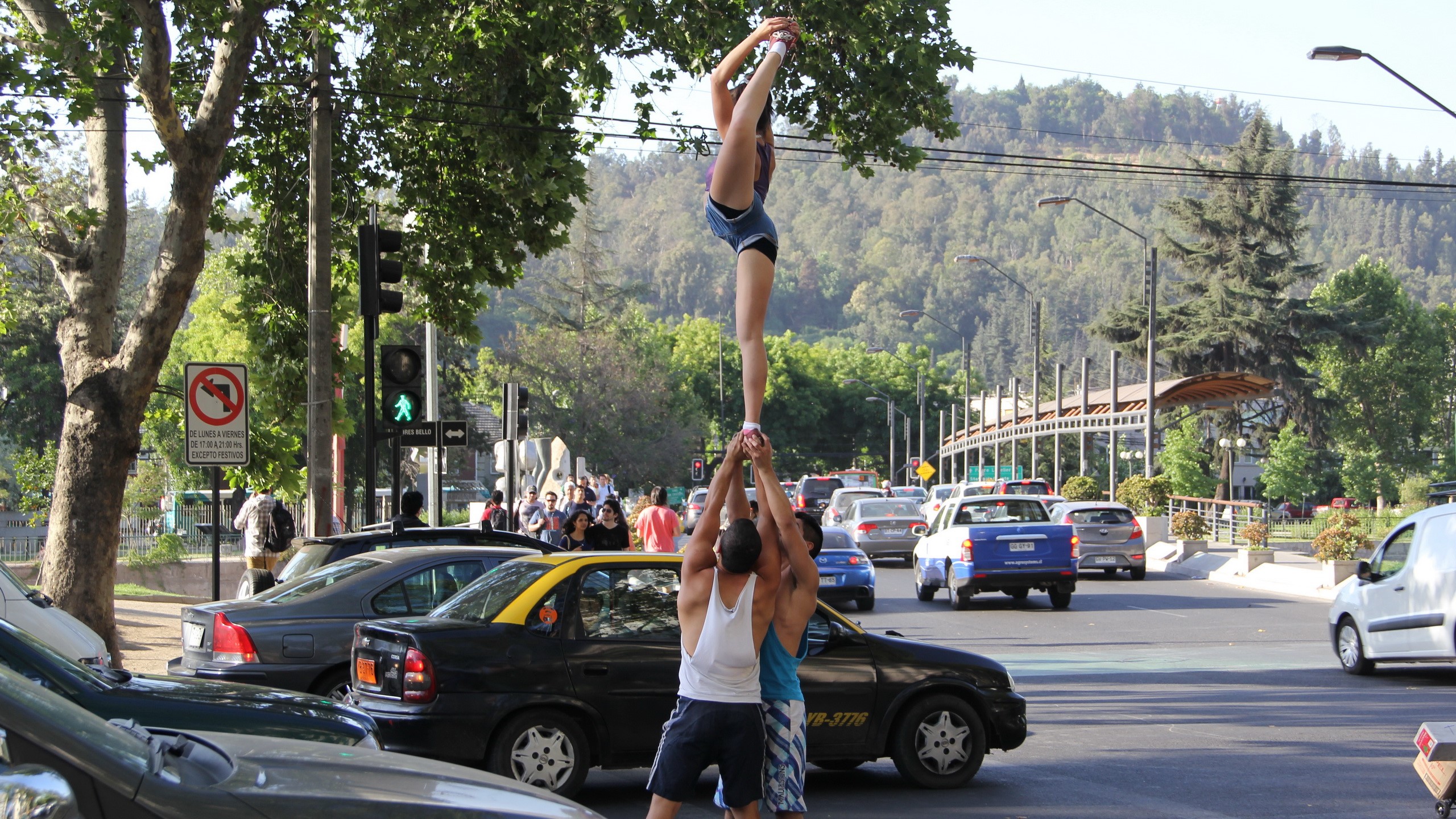 Cheerleaders performing a stunt on cars in Valparaiso, Chile HD Wallpaper