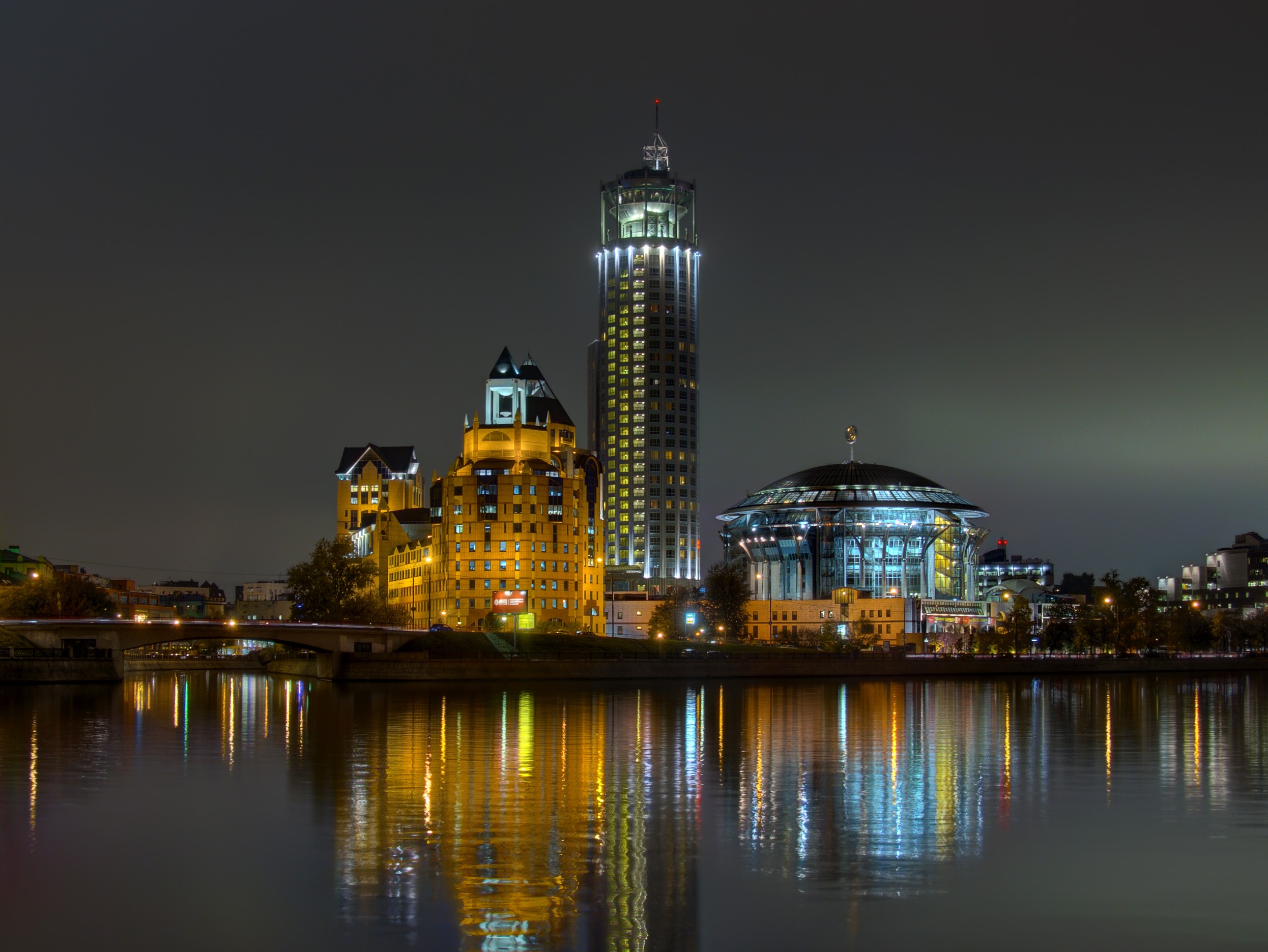 Moscow skyline with illuminated buildings and river at night HD Wallpaper
