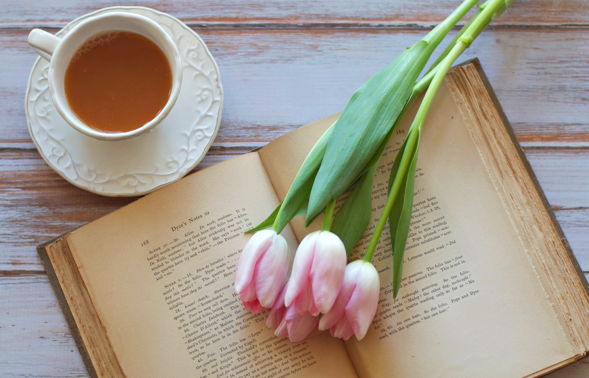 Cup of tea and tulips on an open book HD Wallpaper