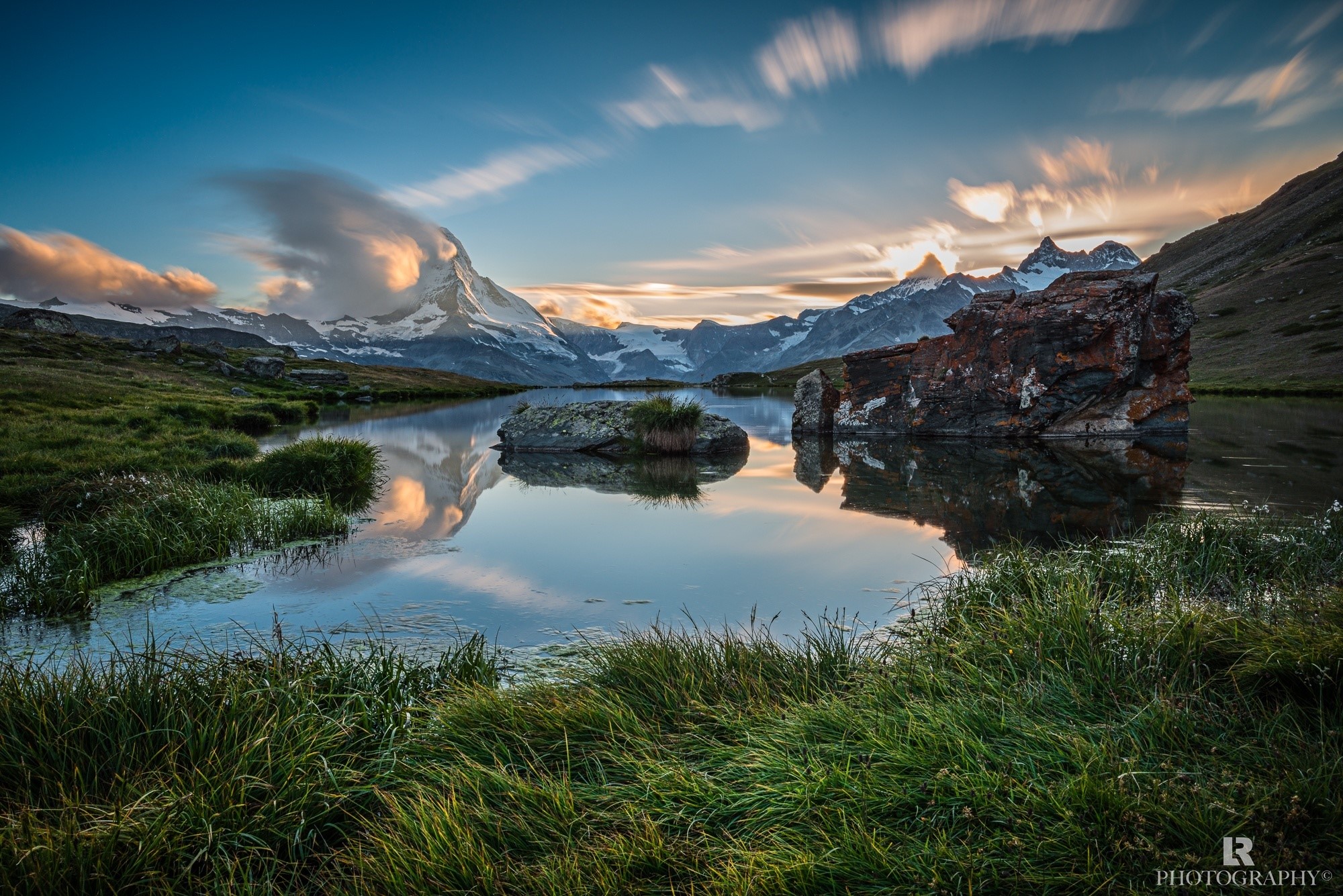 Matterhorn reflected in a mountain lake at sunset HD Wallpaper