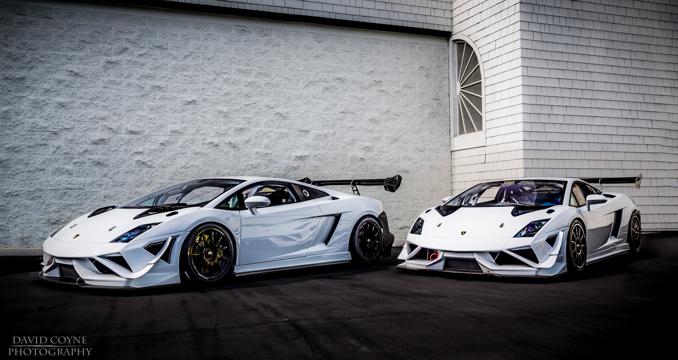 Two white Lamborghini Gallardo cars parked outside HD Wallpaper