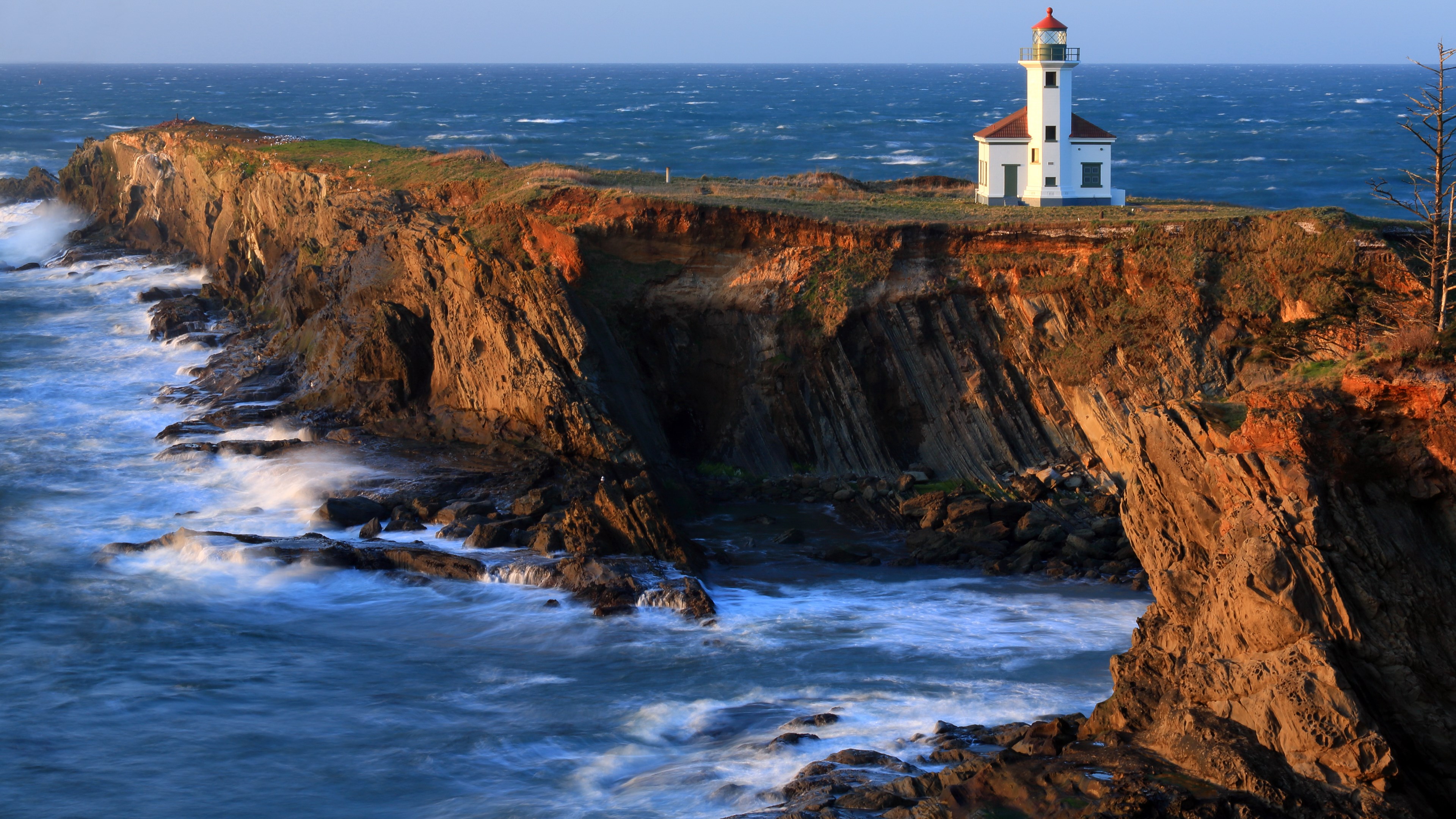 Cape Meares Lighthouse on a cliff overlooking the ocean HD Wallpaper