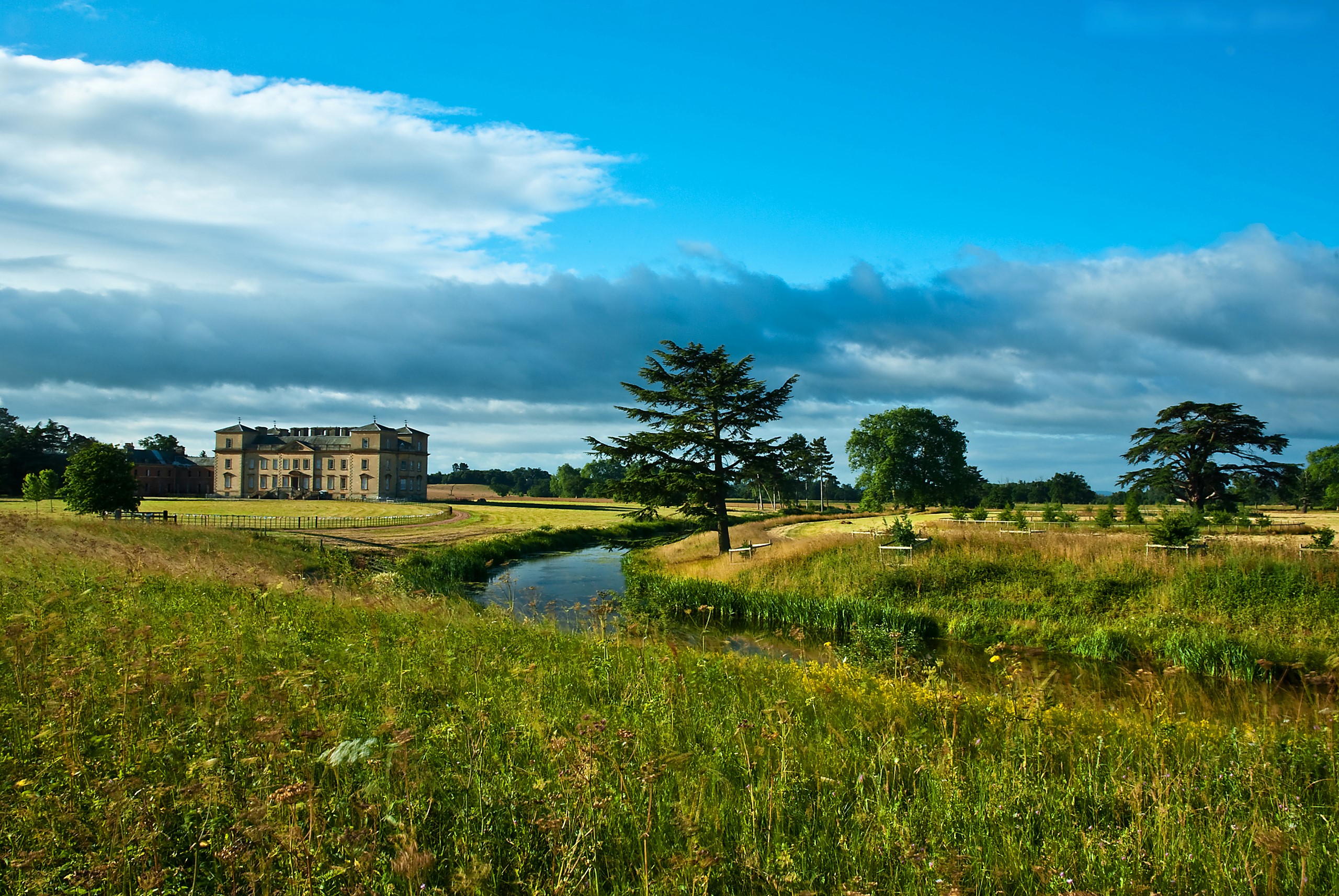 Country house with river and trees under blue sky HD Wallpaper