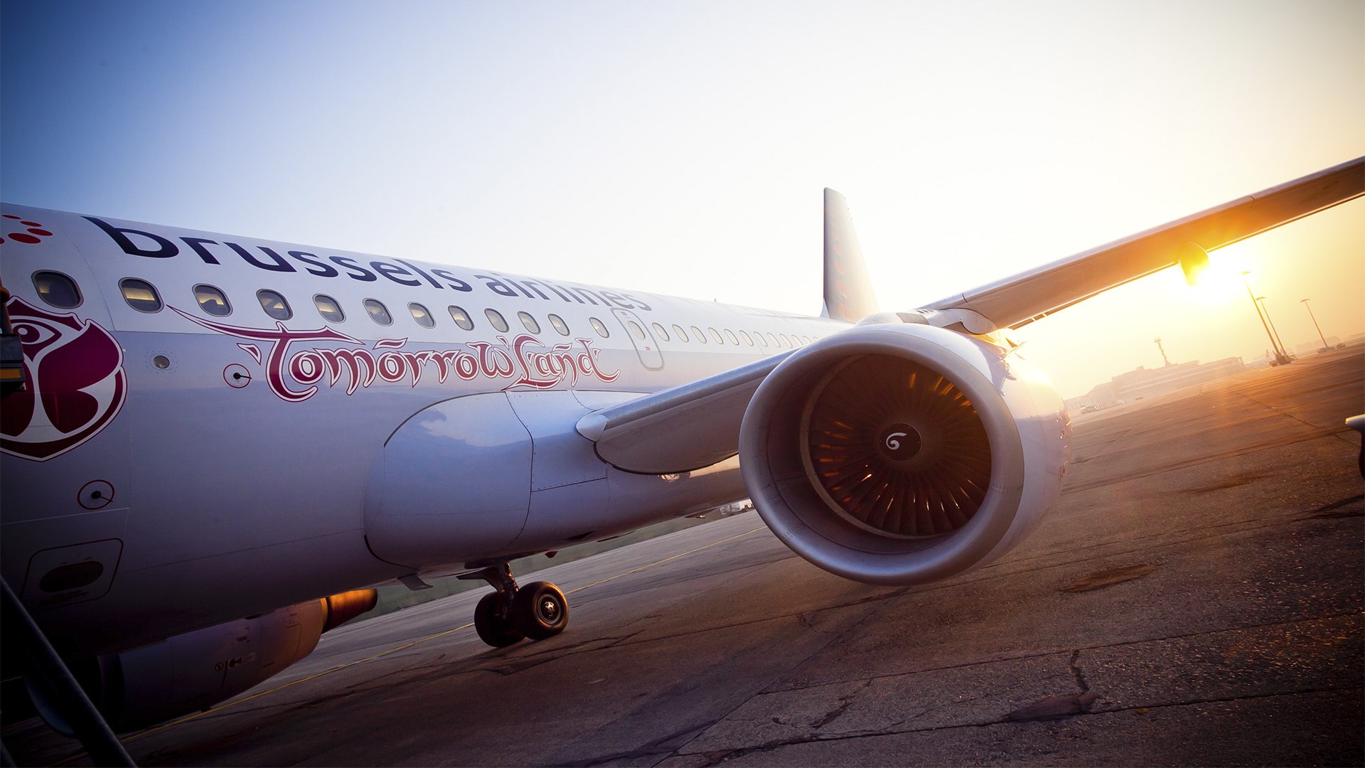 Brussels Airlines Tomorrowland airplane on tarmac at sunset HD Wallpaper
